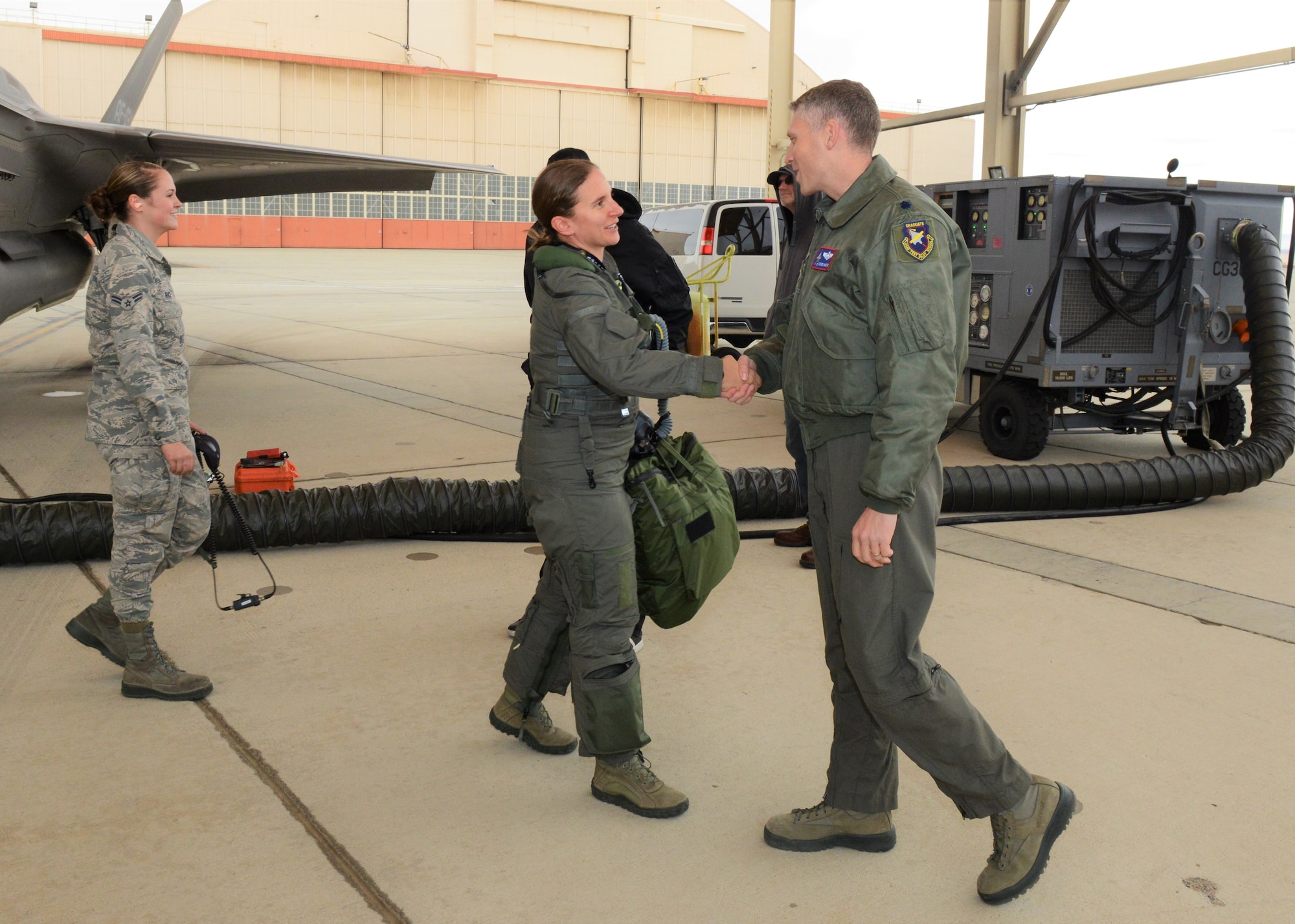 Maj. Rachael Winiecki, 461st Flight Test Squadron F-35 test pilot, is congratulated by Lt. Col. Tucker Hamilton, 461st FLTS commander, after she landed her F-35 Lightning II following her first test mission flight in the fifth-generation fighter Dec. 14, 2018. (U.S. Air Force photo by Kenji Thuloweit)