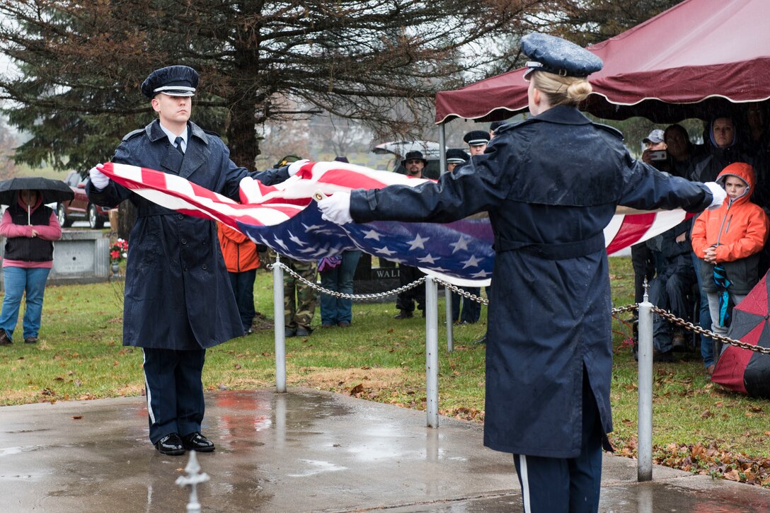 Staff Sgt. Cody Riffle and Staff Sgt. Kayla Hoffmaster, 167th Airlift Wing Base Honor Guard members, perform a flag folding ceremony  at the Wreaths Across America event at Rosedale Cemetary in Martinsburg, W.Va., Dec. 15, 2018, National Wreaths Across America Day.The Mountaineer Defenders Law Enforcement Motorcycle Club hosted the event where more than 600 wreaths were laid on the graves of veterans at Rosedale Cemetary that day. The event at Rosedale Cemetary coincided with the wreath laying at Arlington National Cemetary, as well as more than 1,400 locations in all 50 states. Wreaths Across America’s mission is to remember the fallen U.S veterans, honor those who serve and teach children the value of freedom. (U.S. Air National Guard photos by Senior Master Sgt. Emily Beightol-Deyerle)