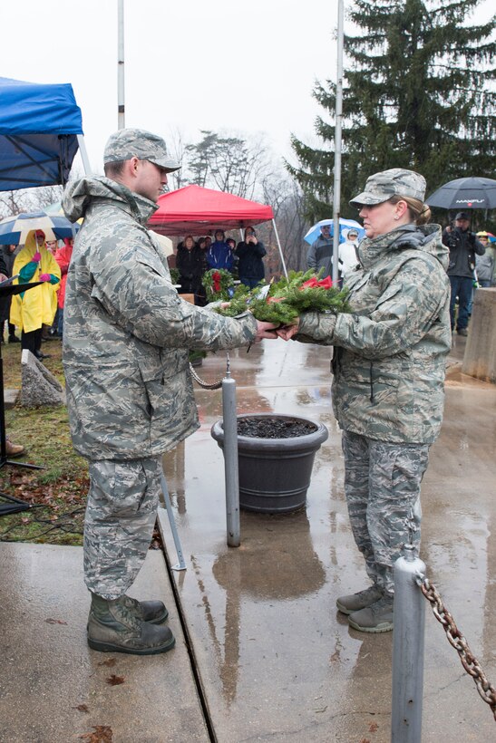 Master Sgt. Keely Andrews, right, presents a wreath to Staff Sgt. Joseph Caviness who had the honor of laying one of the first wreaths at the Wreaths Across America event at Rosedale Cemetary in Martinsburg, W.Va., Dec. 15, 2018, National Wreaths Across America Day.The Mountaineer Defenders Law Enforcement Motorcycle Club hosted the event where more than 600 wreaths were laid on the graves of veterans at Rosedale Cemetary that day. The event at Rosedale Cemetary coincided with the wreath laying at Arlington National Cemetary, as well as more than 1,400 locations in all 50 states. Wreaths
Across America’s mission is to remember the fallen U.S veterans, honor those who serve and teach children the value of freedom. (U.S. Air National Guard photos by Senior Master Sgt. Emily Beightol-Deyerle)