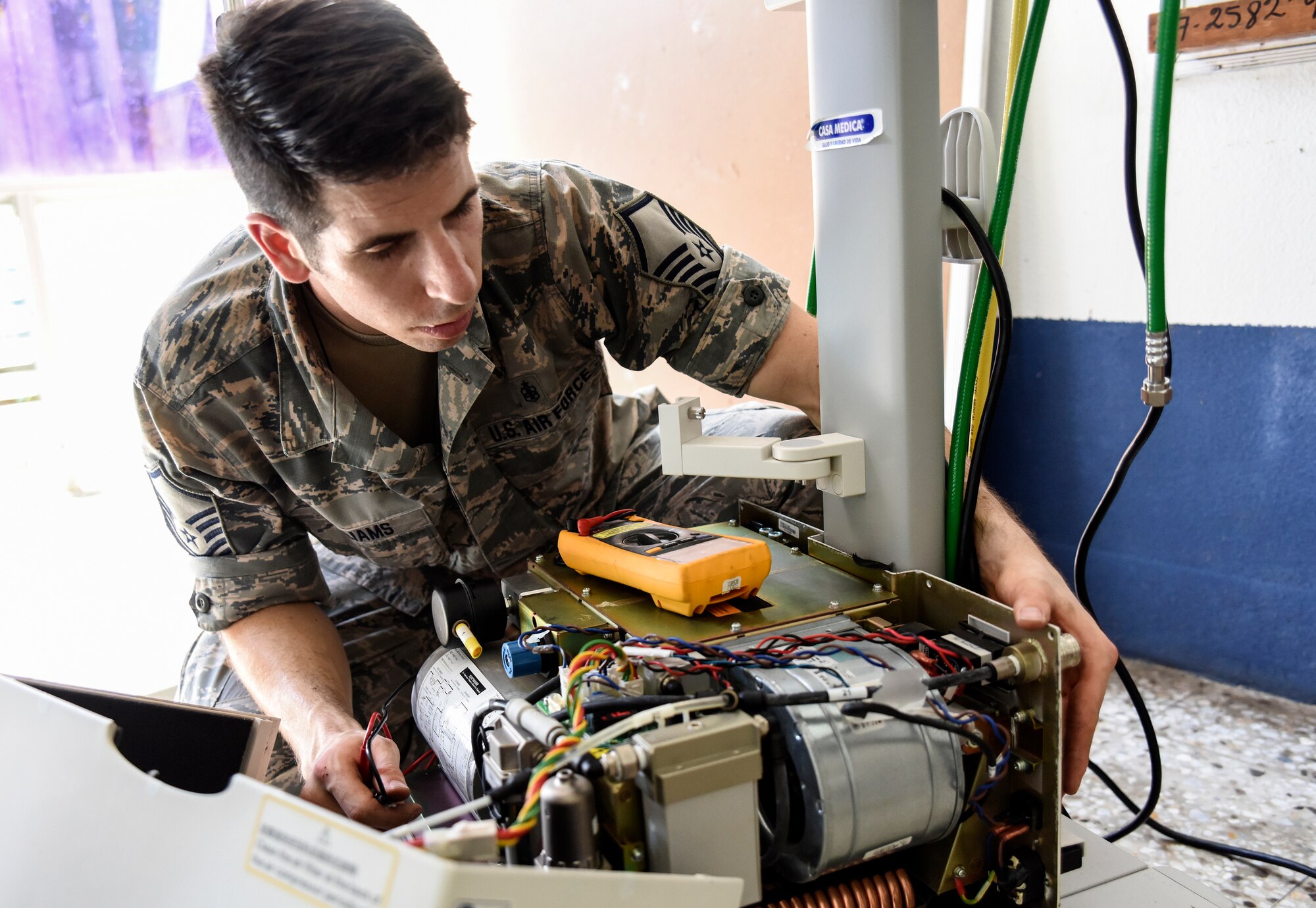 Master Sgt. Colton Guilliams, the 189th Medical Group noncommissioned officer in charge of public health, troubleshoots one of the three ventilators brought in from the neonatal intensive care unit at a hospital in Retalhuleu, Guatemala. Guilliams is a drill status Guard member who works as a biomedical technician in his civilian capacity.