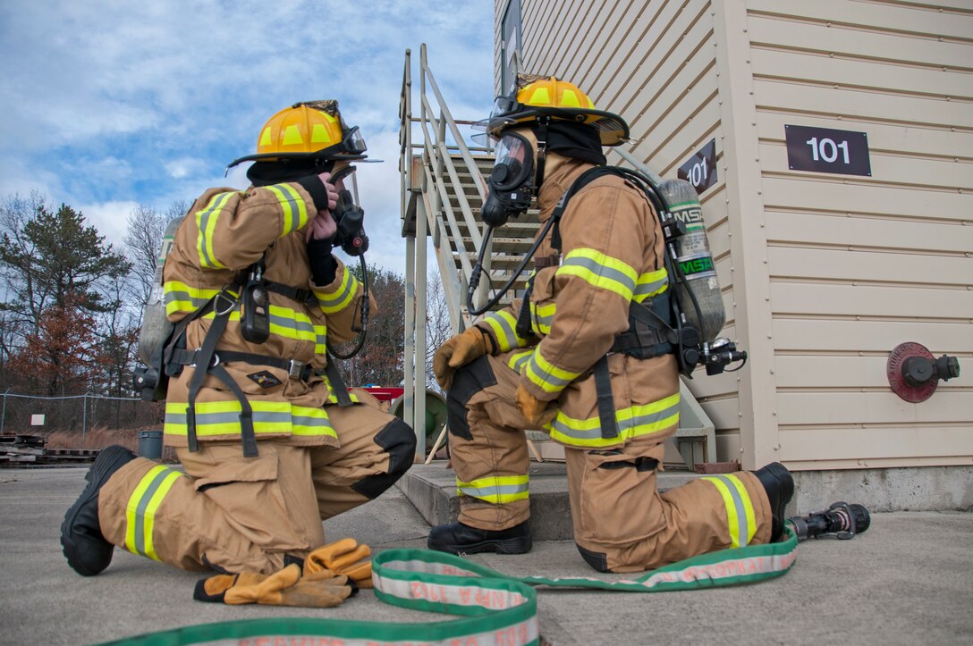 Airman 1st Class Thomas Ruffo and Senior Airman Dylan Nygren, 104th Civil Engineering Squadron firefighters, participate in live structural fire training Nov. 27, 2018, at Barnes Air National Guard Base, Massachusetts. The training ensures the Fire Attack Teams are prepared to respond to any fires on base or in the surrounding communities. (U.S. Air National Guard photo by Airman 1st Class Randy Burlingame)