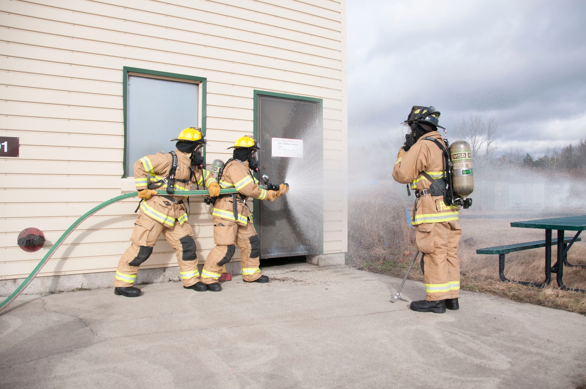 Airman 1st Class Thomas Ruffo and Senior Airman Dylan Nygren, 104th Civil Engineering Squadron firefighters, and Tech. Sgt. Karl Reinholz, 104th CES assistant chief, participate in live structural fire training Nov. 27, 2018, at Barnes Air National Guard Base, Massachusetts. The training ensures the Fire Attack Teams are prepared to respond to any fires on base or in the surrounding communities. (U.S. Air National Guard photo by Airman 1st Class Randy Burlingame)