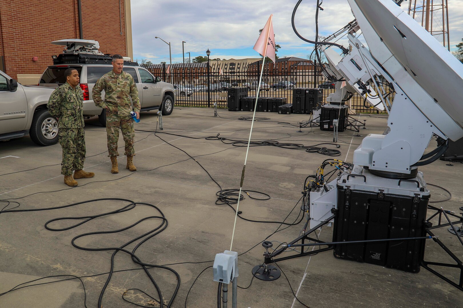 Army Command Sgt. Maj. Paul Biggs, Senior Enlisted Leader for Futures and Concepts Center, a subordinate organization of Army Futures Command in Austin, TX., is briefed by Navy Information Systems Technician First Class Albert Givens, a Deployable Communications SATCOM Technician at Joint Task Force Civil Support (JTF-CS) on the command’s Hawkeye III terminals during a visit to JTF-CS. Futures and Concepts Center is located at Army Training and Doctrine Command, also headquartered at Fort Eustis and adjacent to JTF-CS. The visit was held to foster friendship and teamwork between the military neighbors. (Official DoD photo by Navy Petty Officer Third Class Michael Redd/released)