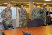 Army Command Sgt. Maj. Paul Biggs, Senior Enlisted Leader for Futures and Concepts Center, a subordinate organization of Army Futures Command in Austin, TX., is briefed by Navy Chief Damage Controlman Benjamin Allen on Joint Task Force Civil Support’s (JTF-CS) Operations department during a visit to JTF-CS. Futures and Concepts Center is located at Army Training and Doctrine Command, also headquartered at Fort Eustis and adjacent to JTF-CS. The visit was held to foster friendship and teamwork between the military neighbors. (Official DoD photo by Navy Petty Officer Third Class Michael Redd/released)