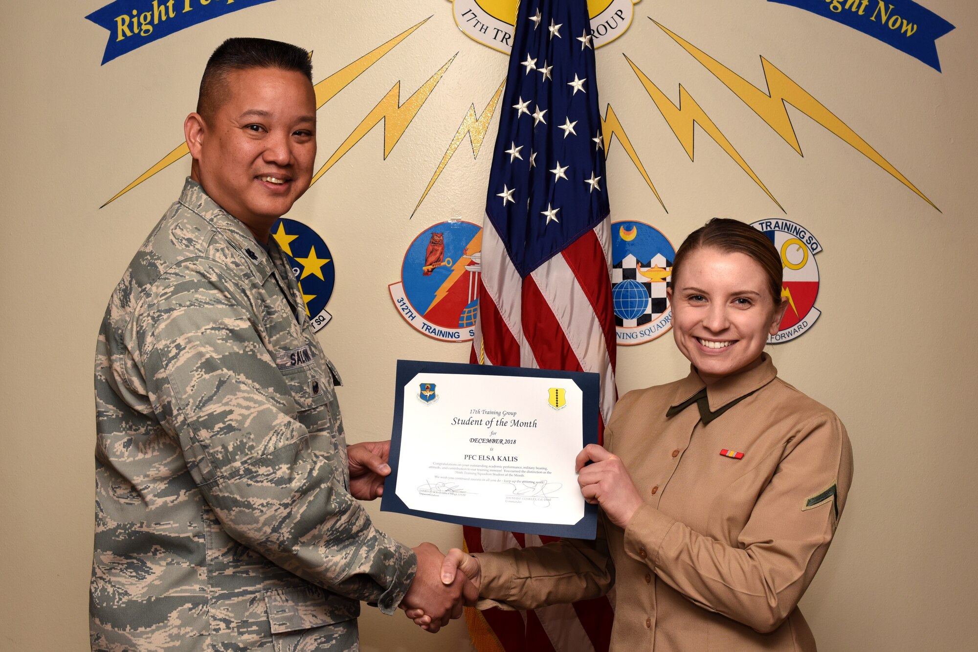 U.S. Air Force Col. Abraham Salomon, 17th Training Group deputy commander, presents the 316th Training Squadron Student of the Month award to U.S. Marine Corps. Pfc. Elsa Kalis, 316th TRS student, at the Brandenburg Hall on Goodfellow Air Force Base, Texas, Jan. 4, 2019. The 316th TRS’s mission is to conduct U.S. Air Force, U.S. Army, U.S. Marine Corps, U.S. Navy and U.S. Coast Guard cryptologic, human intelligence and military training. (U.S. Air Force photo by Airman 1st Class Zachary Chapman/Released)