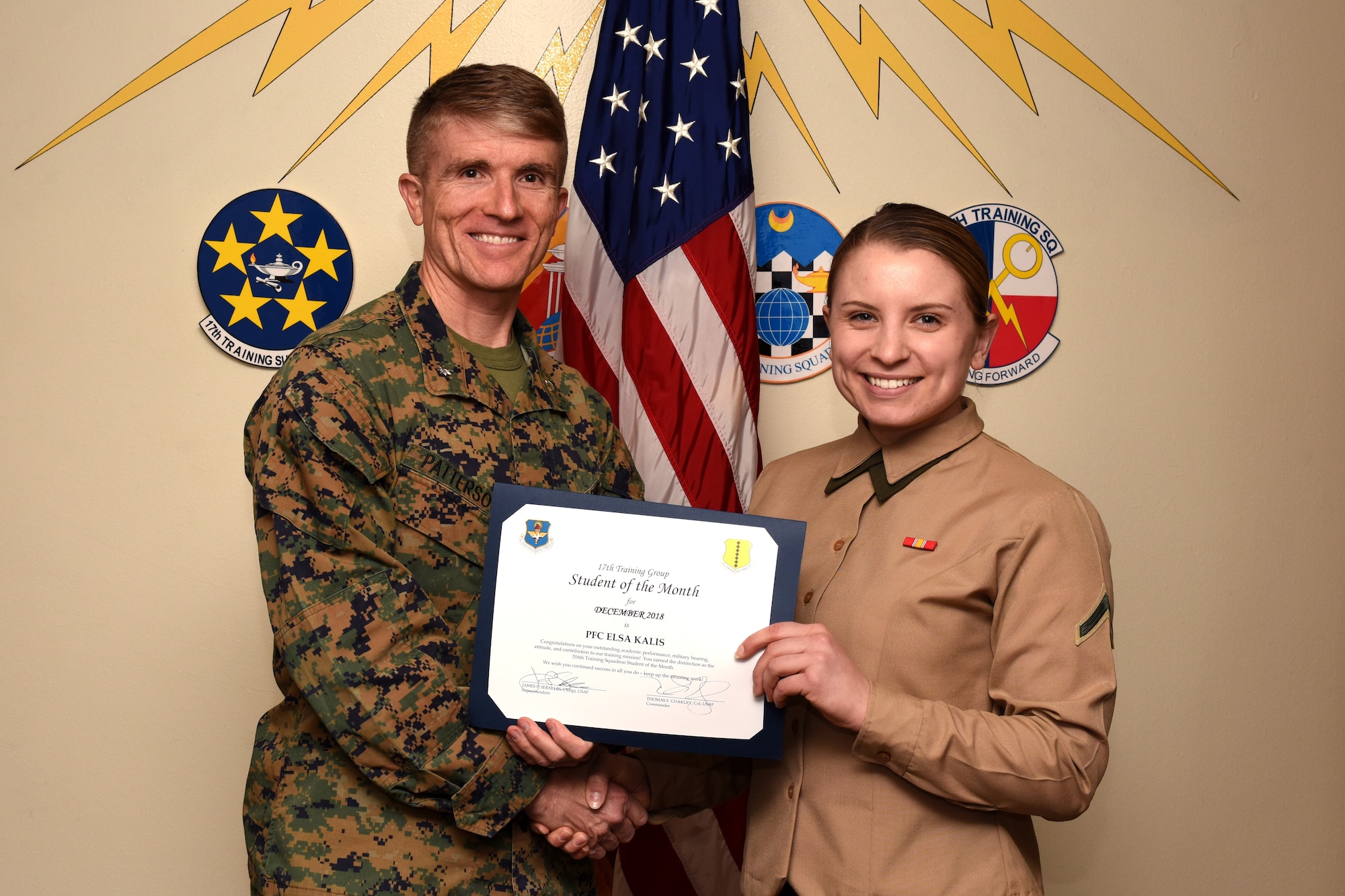 U.S. Marine Corps. Lt. Col. Earl Patterson, Marine Corps. Detachment at Goodfellow commanding officer, presents the 316th Training Squadron Student of the Month award to Pfc. Elsa Kalis, 316th TRS student, at the Brandenburg Hall on Goodfellow Air Force Base, Texas, Jan. 4, 2019. The 316th TRS’s mission is to conduct U.S. Air Force, U.S. Army, U.S. Marine Corps, U.S. Navy and U.S. Coast Guard cryptologic, human intelligence and military training. (U.S. Air Force photo by Airman 1st Class Zachary Chapman/Released)