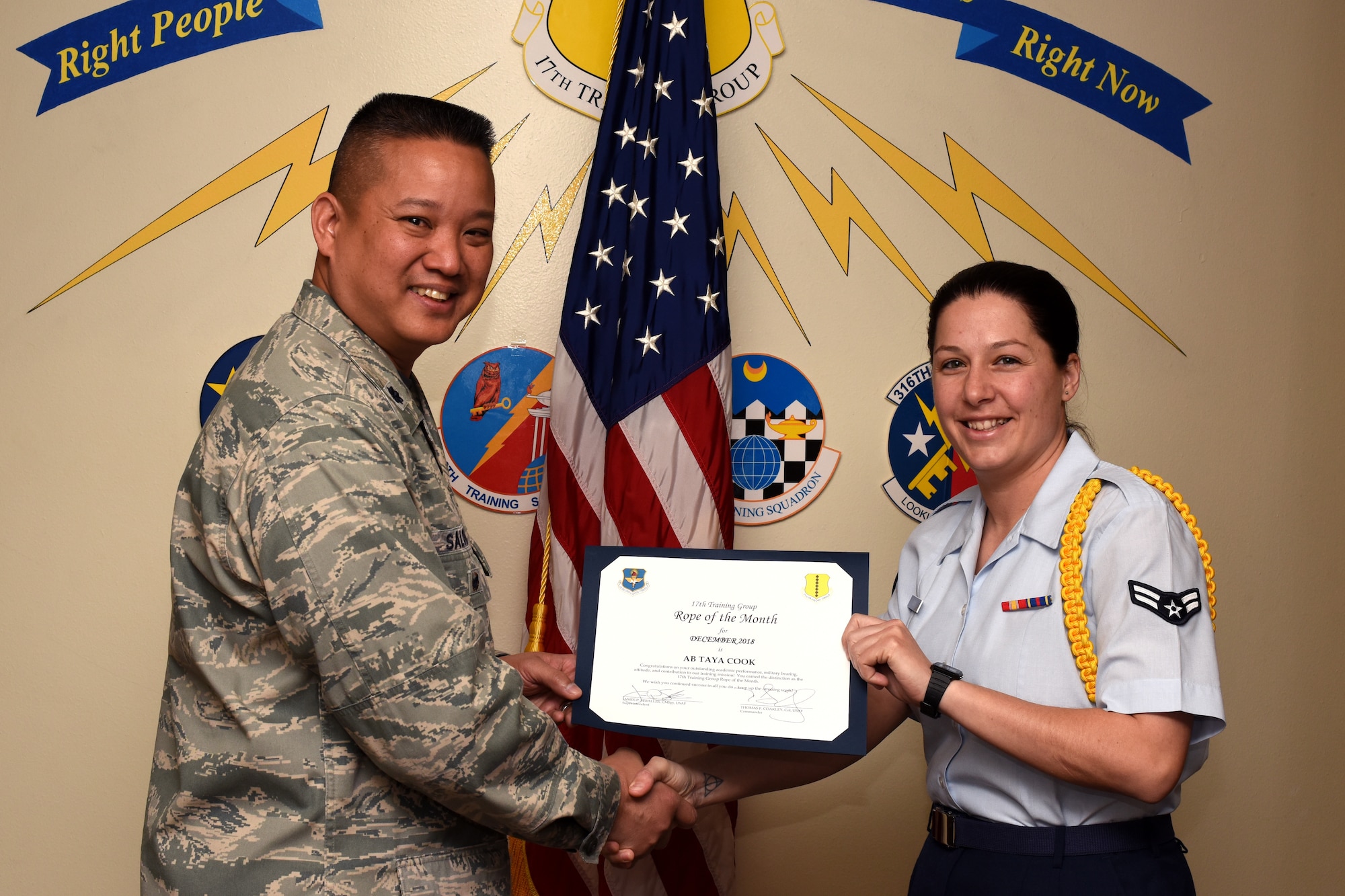 U.S. Air Force Col. Abraham Salomon, 17th Training Group deputy commander, presents the Rope of the Month award to Airman 1st Class Taya Cook, 316th Training Squadron student, at the Brandenburg Hall on Goodfellow Air Force Base, Texas, Jan. 4, 2019. Military Training Leaders present ropes to Airmen who display exceptional leadership qualities to lead their peers. (U.S. Air Force photo by Airman 1st Class Zachary Chapman/Released)