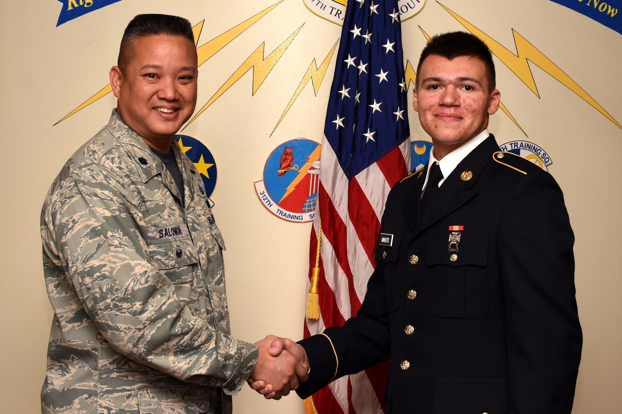 U.S. Air Force Col. Abraham Salomon, 17th Training Group deputy commander, congratulates the 312th Training Squadron Student of the Month winner, U.S. Army Pvt. Christopher Minotti, 312th TRS student, at the Brandenburg Hall on Goodfellow Air Force Base, Texas, Jan. 4, 2019. The 312th TRS’s mission is to provide Department of Defense and international customers with mission ready fire protection and special instruments graduates and provide mission support for the Air Force Technical Applications Center. (U.S. Air Force photo by Airman 1st Class Zachary Chapman/Released)