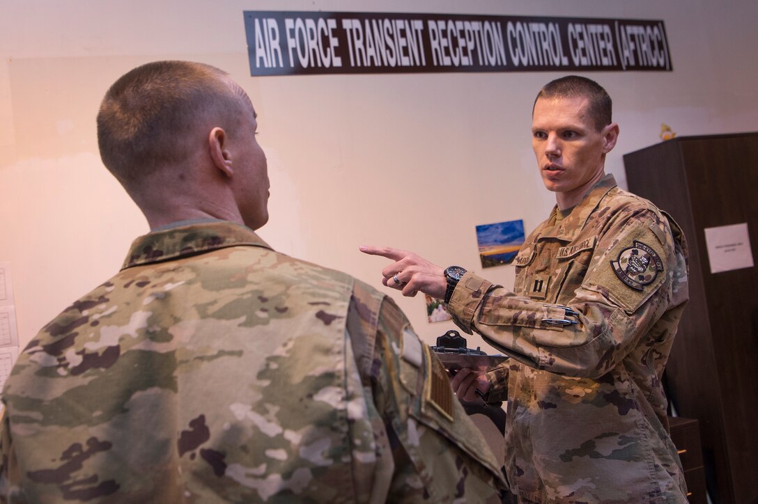 Capt. Jason Argyle, 379th Expeditionary Logistics Readiness Squadron (ELRS) Air Force Transient Reception Control Center installation deployment officer, provides rotator information to an Airman at Al Udeid Air Base, Qatar, Jan. 5, 2019. 379th ELRS log planners relay transportation information to service members traveling to deployed locations across U.S. Central Command’s area of responsibility. They provide warfighters in transition support including lodging, means of communication and vehicles to ensure mission effectiveness as they wait for forward deployment.  (U.S. Air Force photo by Tech. Sgt. Christopher Hubenthal)
