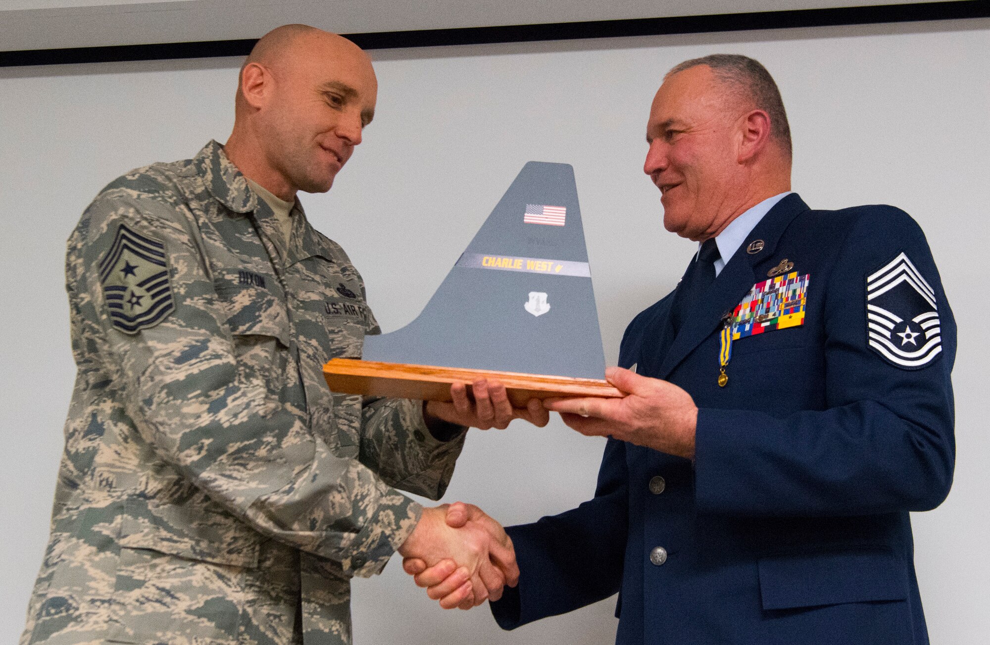 Chief Master Sgt. Jame Dixon, West Virginia Air National Guard State Command Chief, presents a tail flash to Chief Master Sgt. Fred Turner during a formal retirement ceremony held Jan. 4, 2019, at McLaughlin Air National Guard Base, Charleston, W.Va. Turner served in the California and West Virginia Air National Guard for 41 years cumulatively and was also the 12th State Command Chief for the West Virginia Air National Guard. (U.S. Air National Guard photo by Master Sgt. De-Juan Haley)