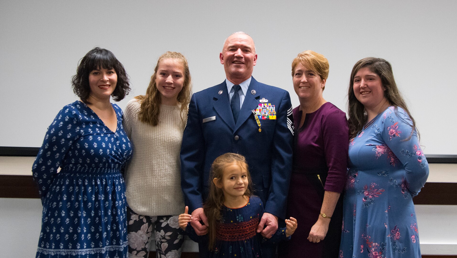 The family and friends of Chief Master Sgt. Fred Turner pose for a photo following a formal retirement ceremony held in his honor Jan. 4, 2019, at McLaughlin Air National Guard Base, Charleston, W.Va. Turner served in the California and West Virginia Air National Guard for 41 years cumulatively and was also the 12th State Command Chief for the West Virginia Air National Guard. (U.S. Air National Guard photo by Master Sgt. De-Juan Haley)