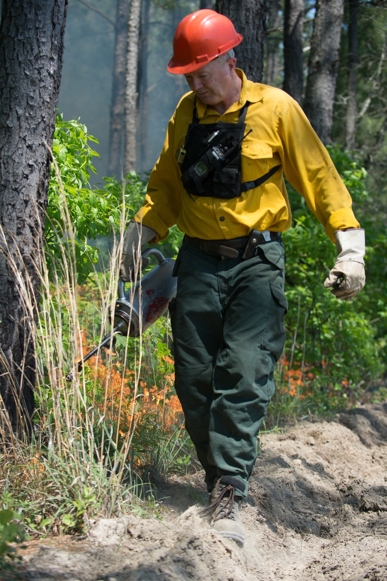 Terrence Larimer, natural resources manager assigned to the 628th Civil Engineering Squadron, uses a hand-held torch during a prescribed fire operation at the Joint Base Charleston Naval Weapons Station, May 6, 2014.