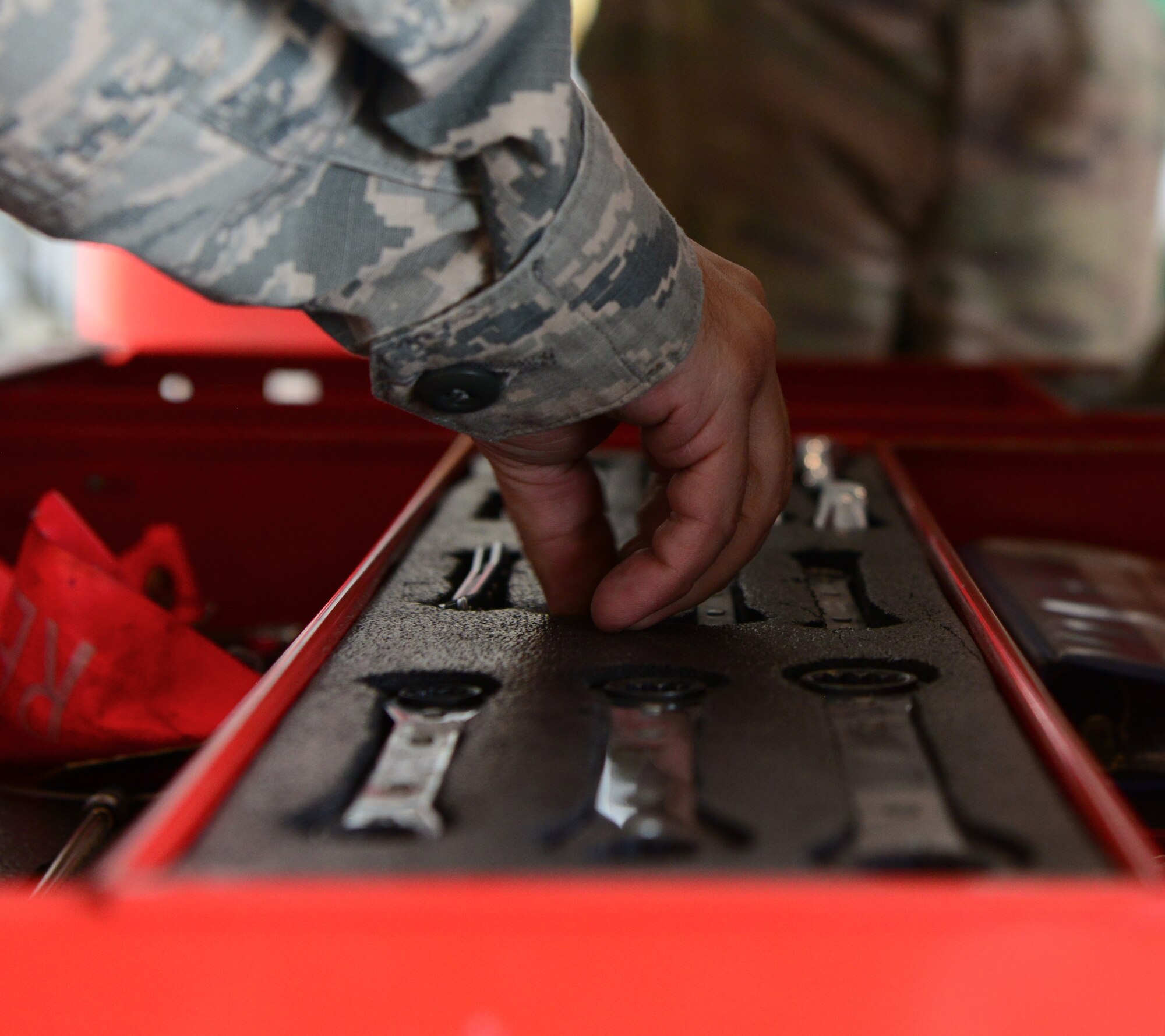 Tech. Sgt. Stephen Bartorillo, 9th Maintenance Squadron repair and reclamation craftsman, grabs a wrench from a tool box needed to complete phase maintenance on a U-2 Dragon Lady