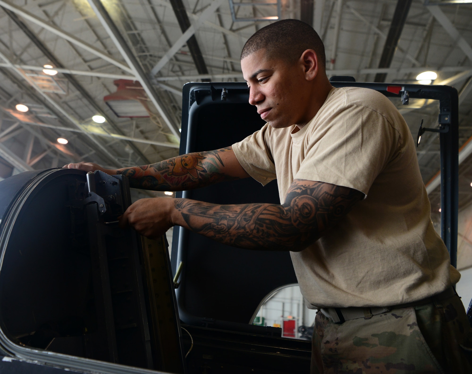 Staff Sgt. Terrance Walker, 9th Maintenance Squadron repair and reclamation craftsman, loosens a bolt on the canopy jettison system on a U-2 Dragon Lady.