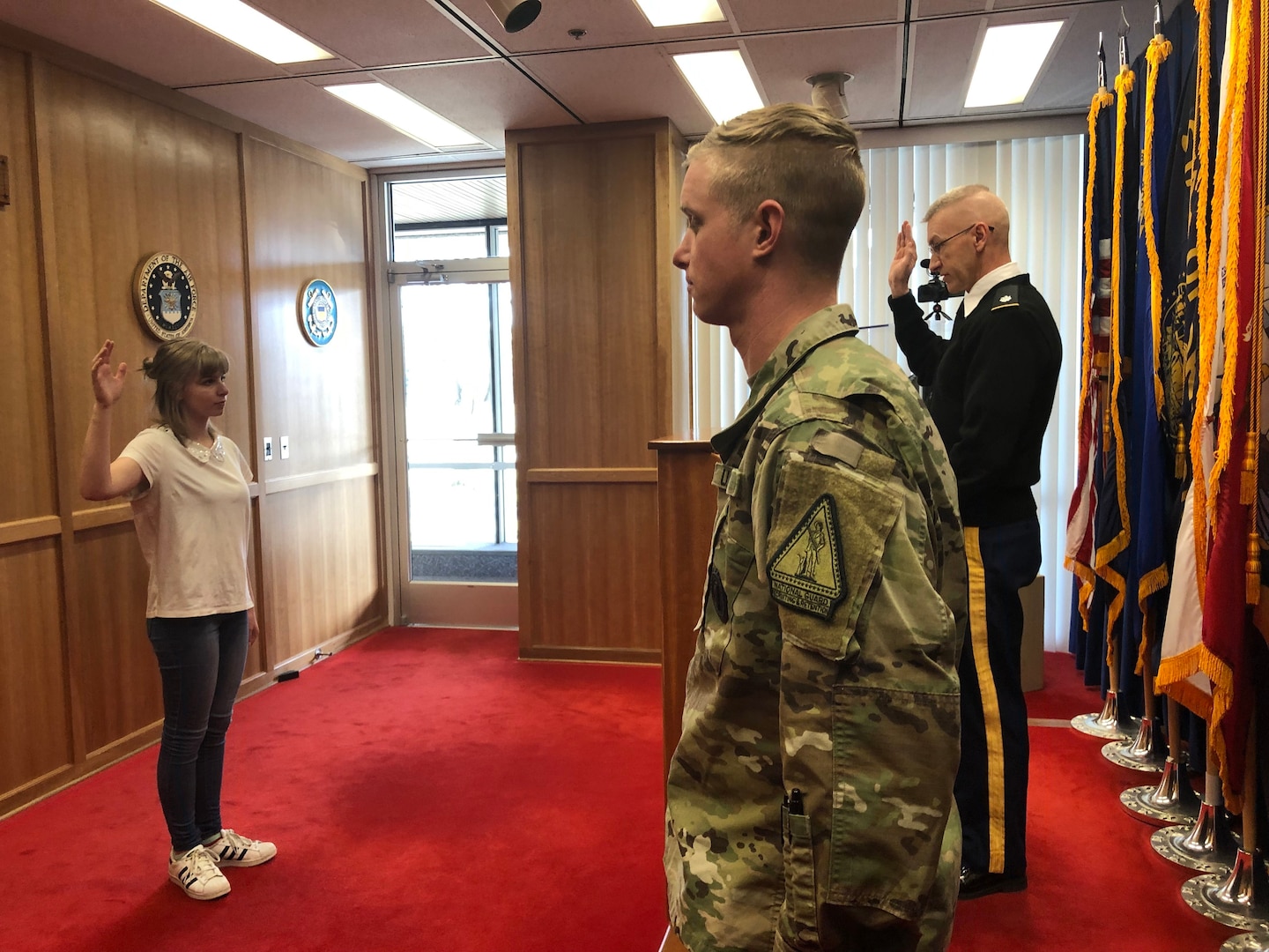 Lt. Col. David Darney administers the oath of enlistment to his daughter, Pvt. Sarah Darney, Dec. 27, 2018, at the Boise Military Entrance Processing Station.