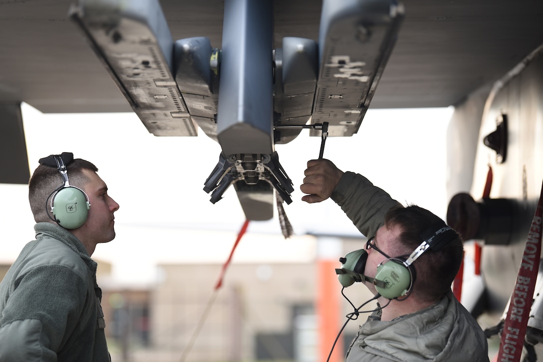 492nd Aircraft Maintenance Unit weapons load crew members conduct maintenance on an F-15E Strike Eagle pylon at Royal Air Force Lakenheath, England, Jan. 7, 2019. Aircraft maintainers work together in their respective specialties to ensure the Strike Eagles are always ready to fly. (U.S. Air Force photo by Airman 1st Class Shanice Williams-Jones)