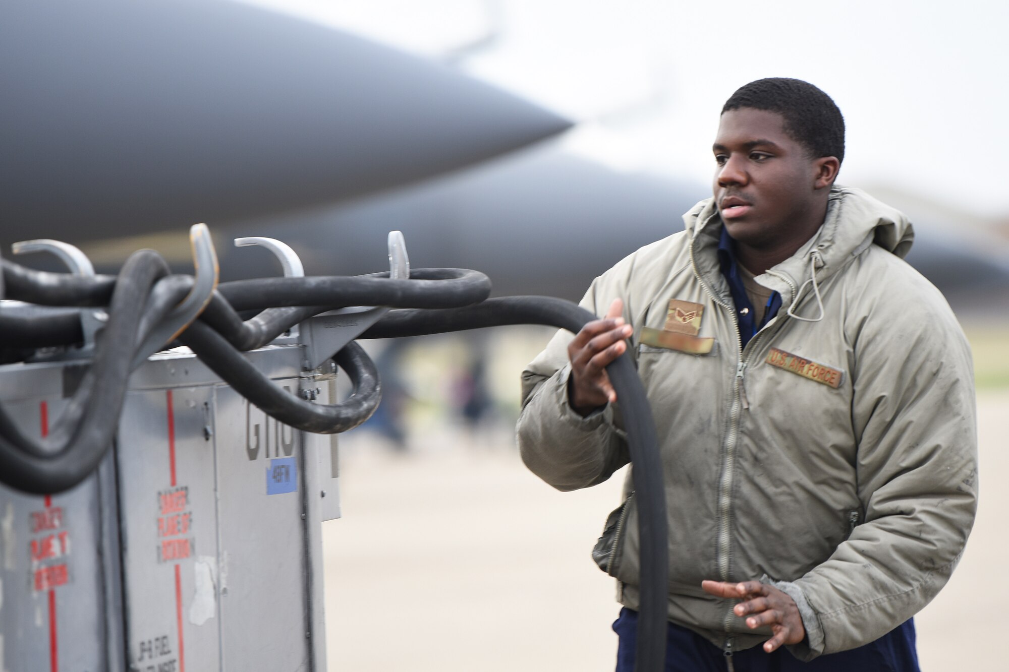 A 492nd Aircraft Maintenance Unit crew chief wraps up maintenance equipment after completing a functional inspection at Royal Air Force Lakenheath, England, Jan. 7, 2019. 48th Aircraft Maintenance Squadron Airmen maintain world's premier multi-role fighter, the F-15E Strike Eagle, to ensure RAF Lakenheath remains combat-ready. (U.S. Air Force photo by Airman 1st Class Shanice Williams-Jones)