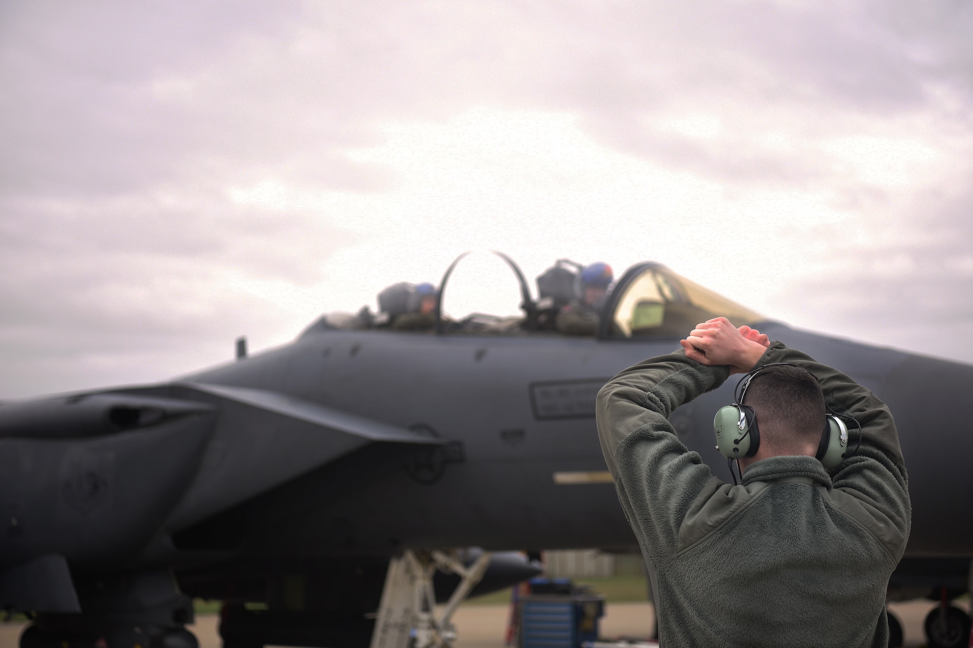 A 492nd Aircraft Maintenance Unit crew chief marshals an F-15E Strike Eagle at Royal Air Force Lakenheath, England, Jan. 7, 2019. Aircraft marshalling is a method of visual communication between aircrew and crew chiefs as an alternative to radio communication. (U.S. Air Force photo by Airman 1st Class Shanice Williams-Jones)