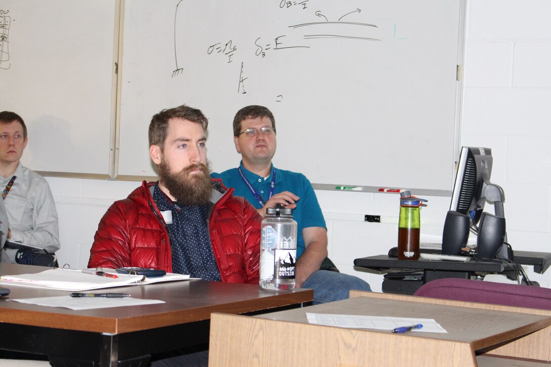 Austin Voorhes, far right, a Test Systems Design supervisor for the Test Operations and Sustainment contract at Arnold Air Force Base, leads a Process Piping Training session in the G-Range Conference Room at Arnold on Dec. 12. Engineers base wide, both contractor and Air Force, attended the training to learn the requirements to prevent piping system failures. (U.S. Air Force photo by Deidre Ortiz) (Image was altered by obscuring badges for security purposes)