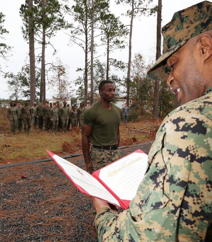 Sgt. Darius L. Warren, supply administration and operations specialist, G6, Marine Corps Logistics Command, stands at attention during his reenlistment ceremony.