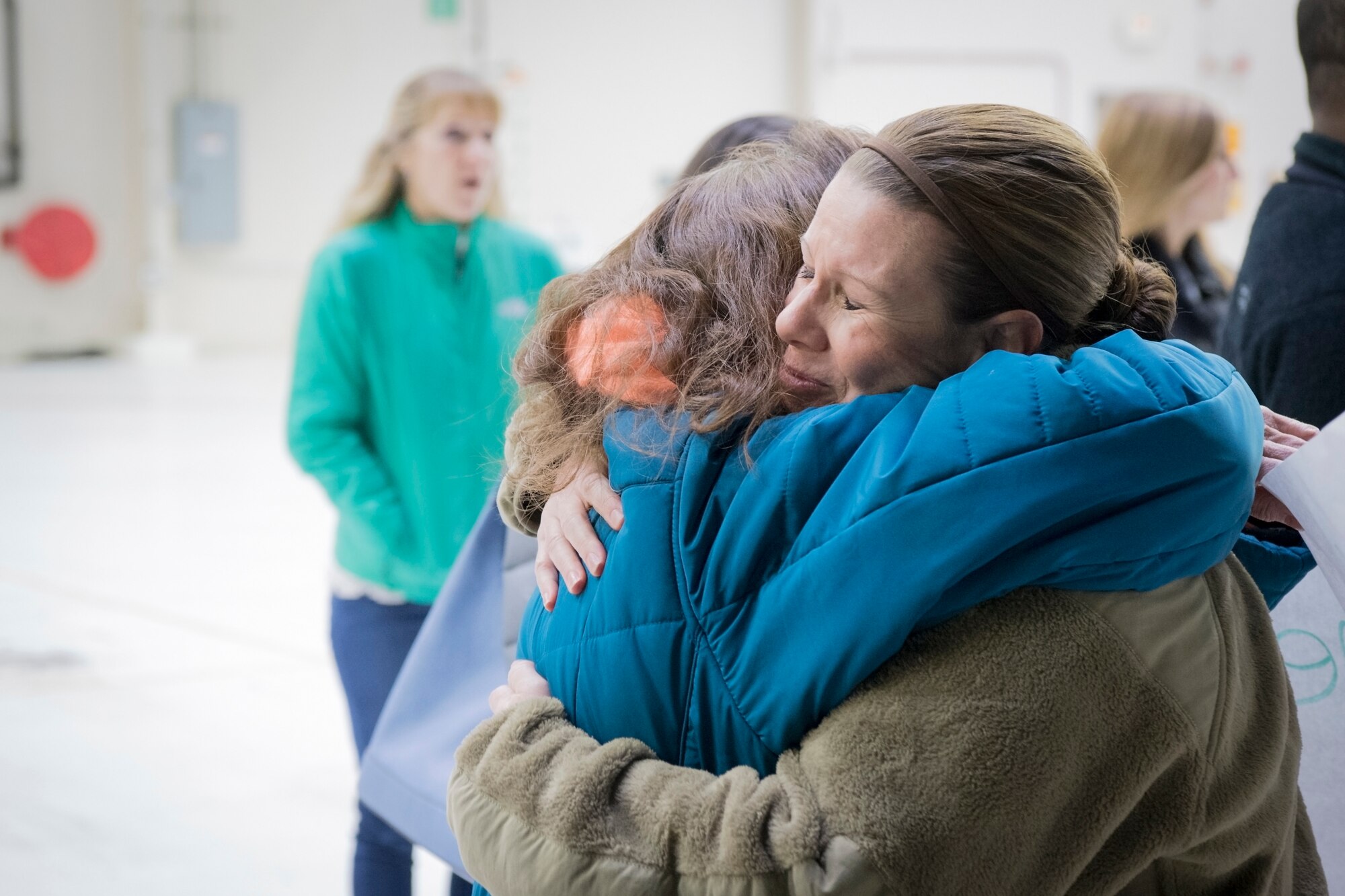 Tech. Sgt. Christina Howland, 434th Operations Support Squadron aircrew flight equipment NCOIC, hugs her mother, Karen Lile, after arriving at Grissom Air Reserve Base, Ind. Jan. 8, 2019. Howland was one of 18 Airmen and three KC-135s who returned home following a deployment to Southwest Asia. (U.S. Air Force photo / Master Sgt. Ben Mota)