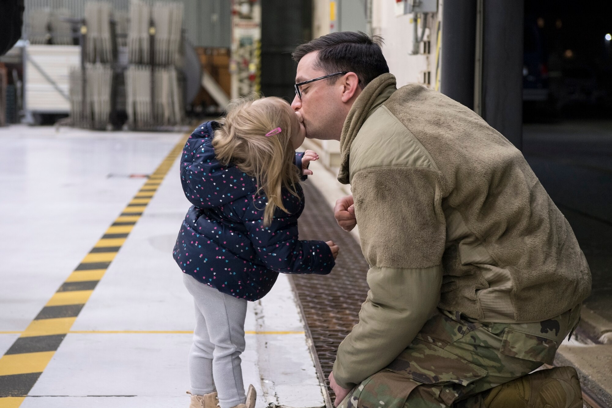 Staff Sgt. William Ellison, 434th Operations Support Squadron radio communication system specialist, embraces his daughter Gwendolyn, 2, after arriving at Grissom Air Reserve Base, Ind. Jan. 8, 2019. Ellison was one of 18 Airmen and three KC-135s who returned home following a deployment to Southwest Asia. (U.S. Air Force photo / Master Sgt. Ben Mota)
