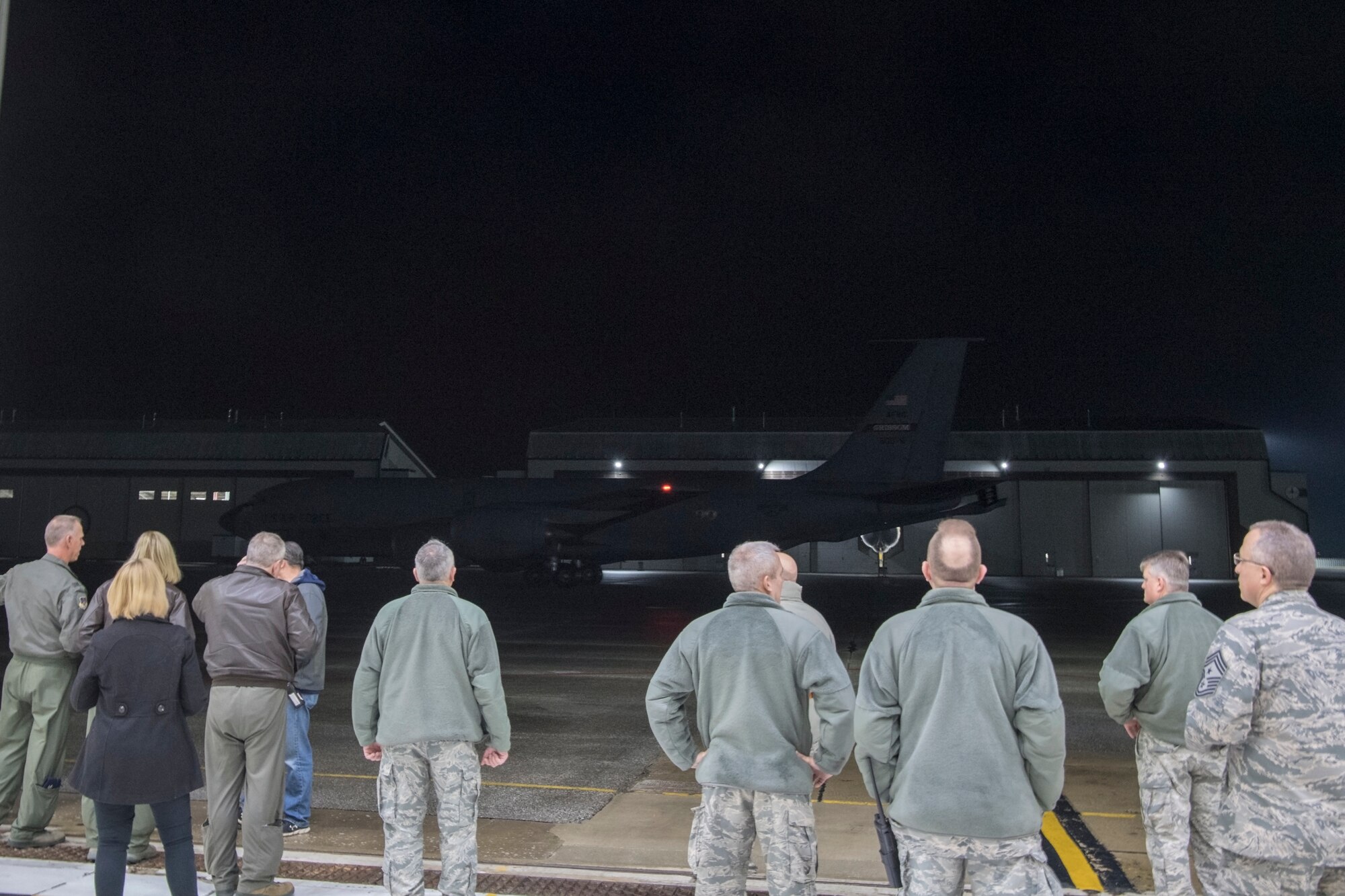 Leadership from the 434th Air Refueling wing wait to greet returning Airmen as their KC-135R Stratotanker taxis outside a hangar at Grissom Air Reserve Base, Ind., Jan. 8 2019. A total of 18 Airmen and three KC-135Rs returned in the early hours following a deployment to Southwest Asia. (U.S. Air Force photo / Master Sgt. Ben Mota)