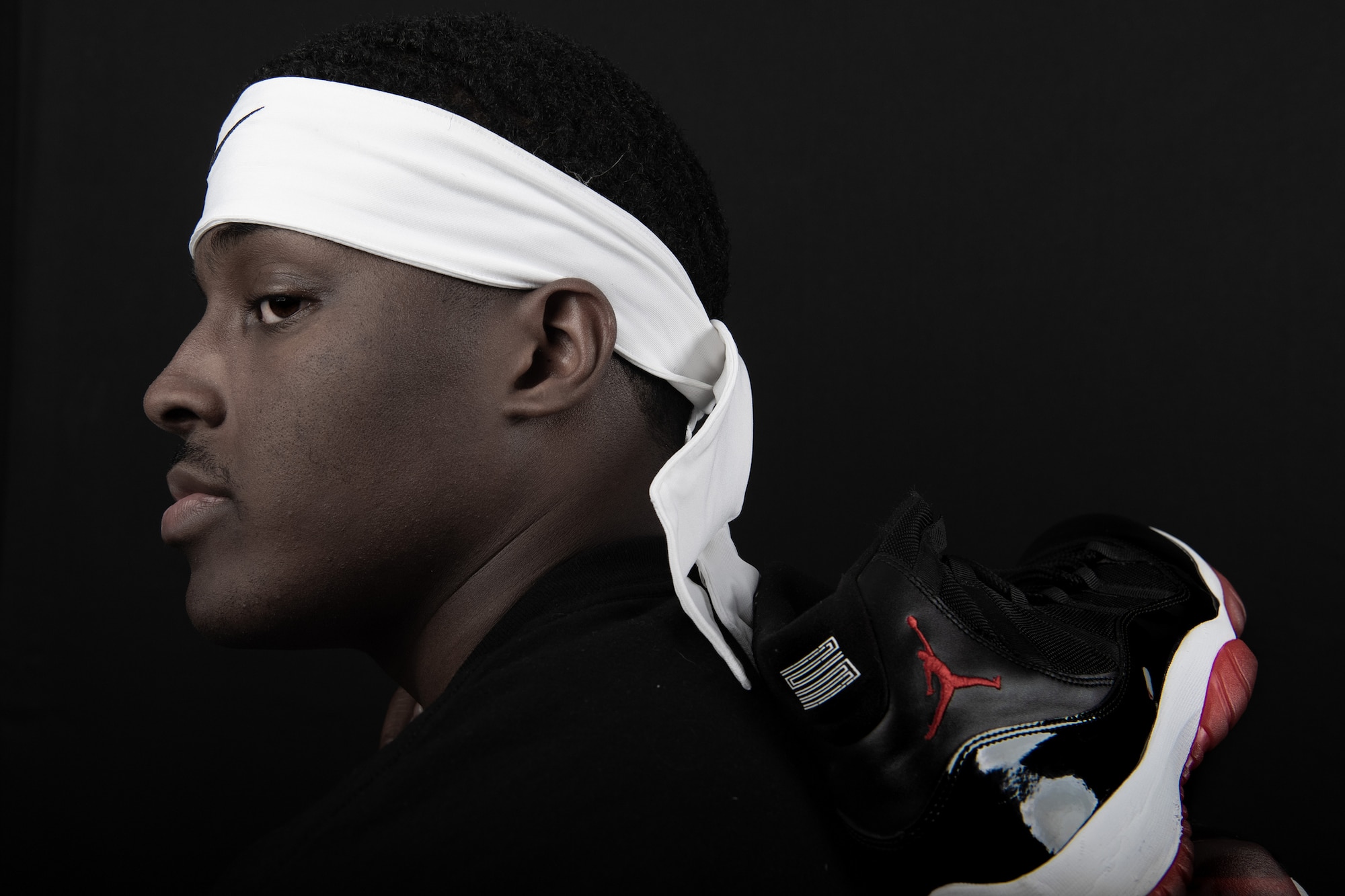U.S. Air Force Airman 1st Class Yaquis Cole, 377th Weapons System Security Squadron, poses with his favorite pair of basketball shoes, retro Jordan 11 'breds" for a portrait at Kirtland Air Force Base, N.M., Dec. 12, 2018. Cole is the team captain for the 377th WSSS basketball team and is hoping to win a championship for his squadron. (U.S. Air Force photo by Staff Sgt. J.D. Strong II)