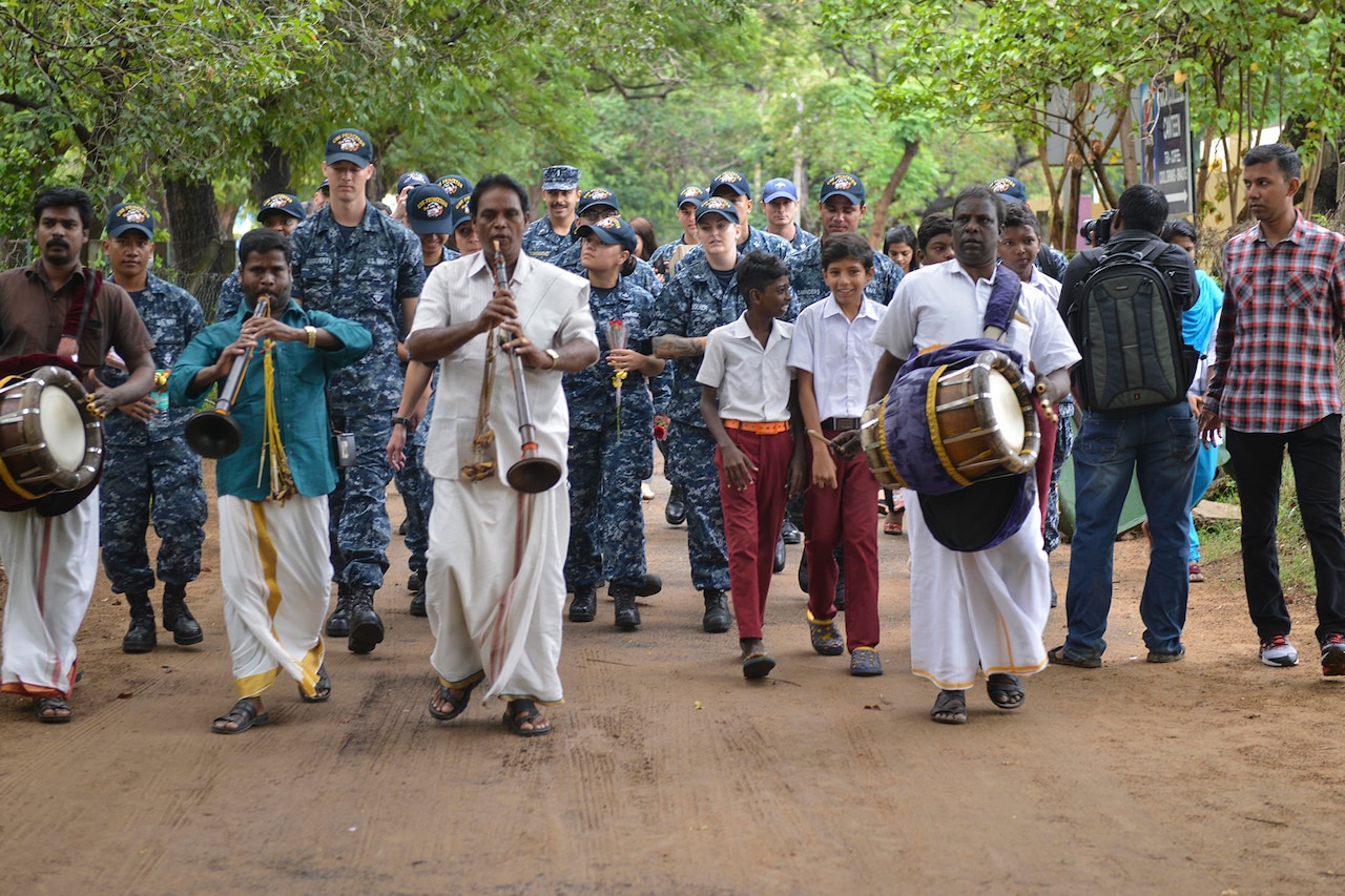 Sailors are greeted by locals.