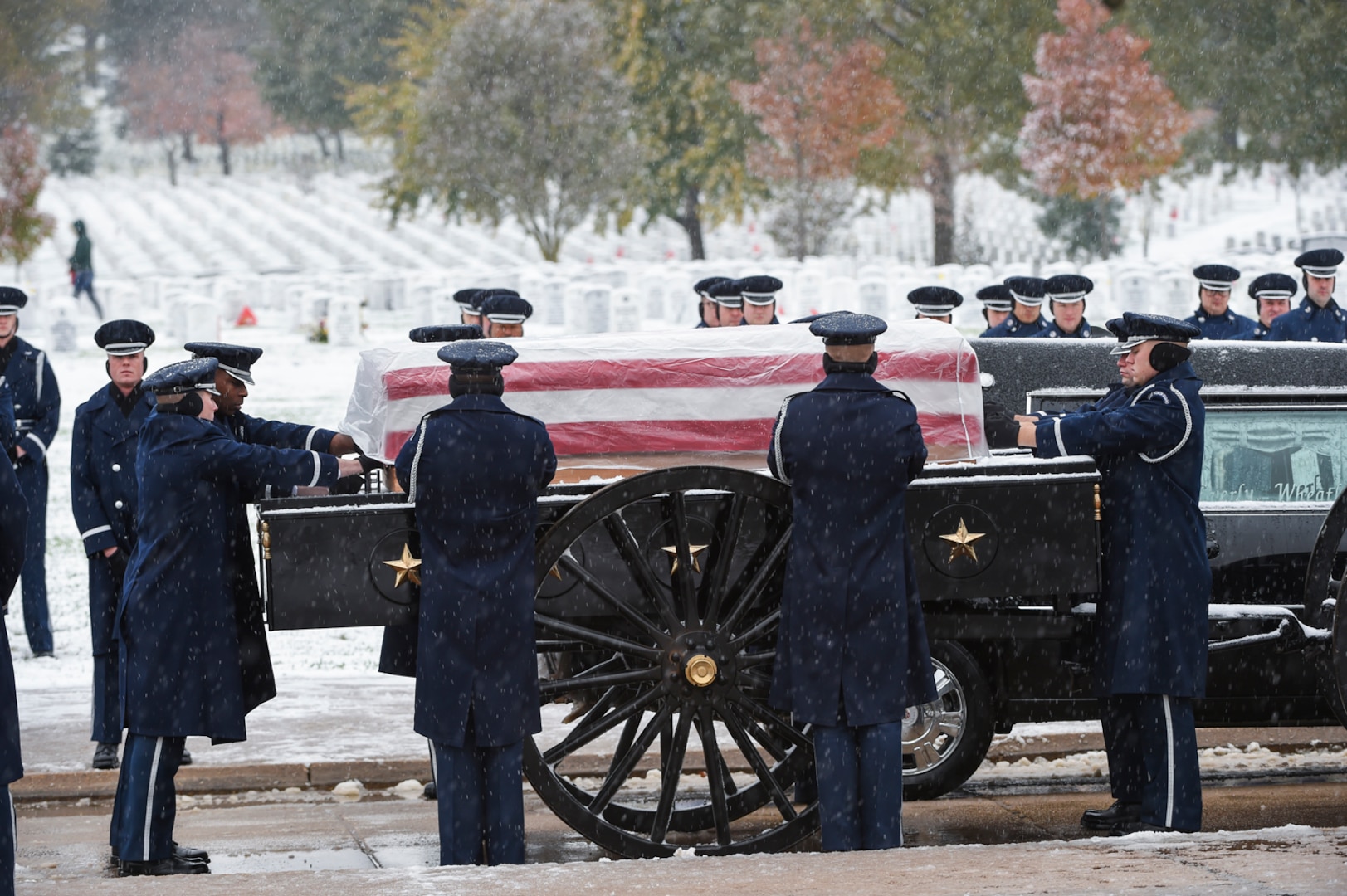 Members of the U.S. Air Force casket team prepares to lift the casket of the late Chief Master Sgt. Therese Henrion during a burial ceremony at Arlington National Cemetery, Nov. 15, 2018.