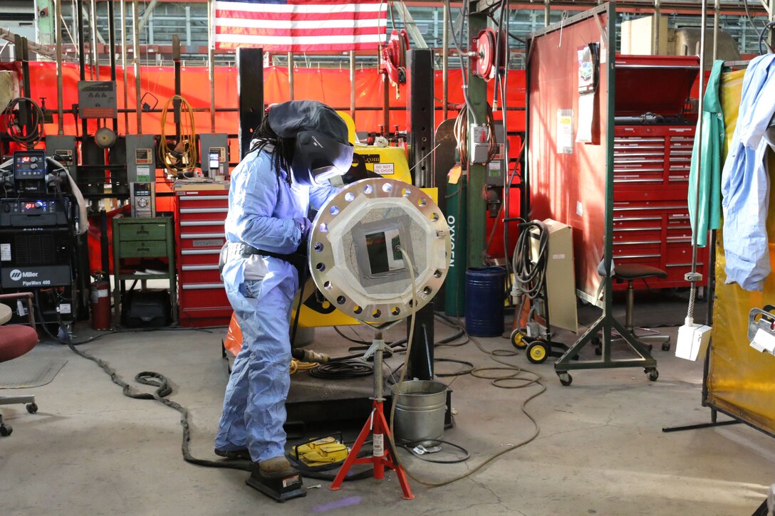 Tony Bigsby, pipefitter in the Model and Machine Shop at Arnold Air Force Base, welds a pipe for one of the test cells on base. Bigsby is one of about 40 craft workers in the Model Shop certified to perform welding. The welders support general operations at Arnold, including the repair of existing infrastructure, and testing, including the fabrication of piping for test cells. They also perform various types of welding on a variety of metals. (U.S. Air Force photo by Bradley Hicks) (This image was altered by obscuring badges for security purposes)