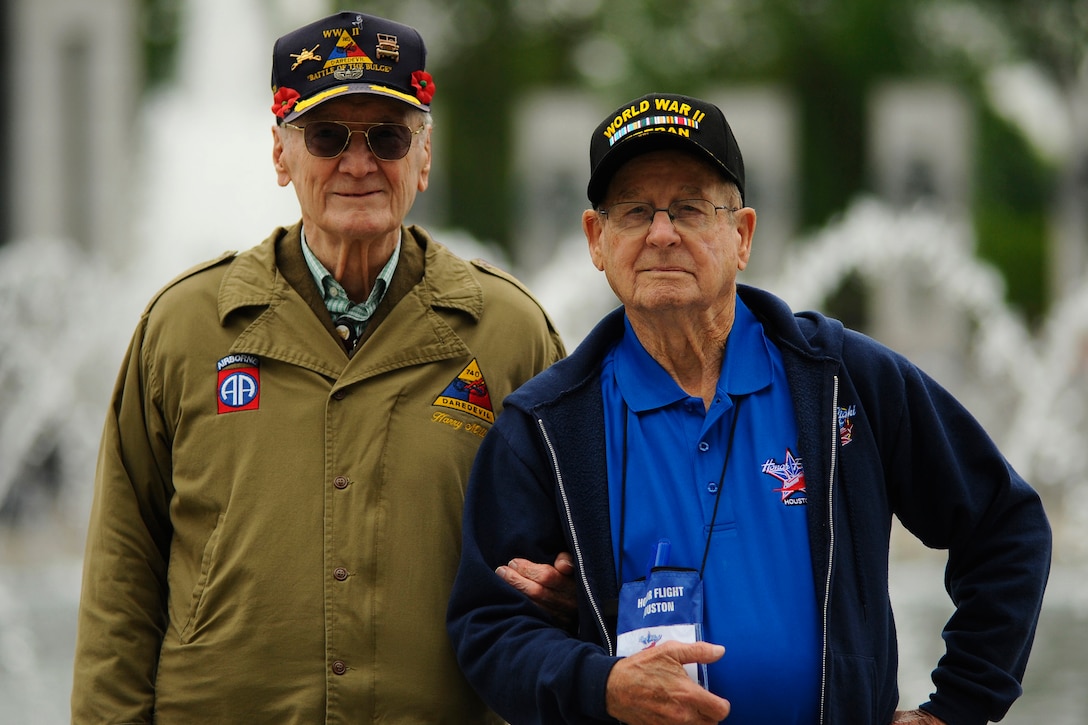 Two men stand side by side.