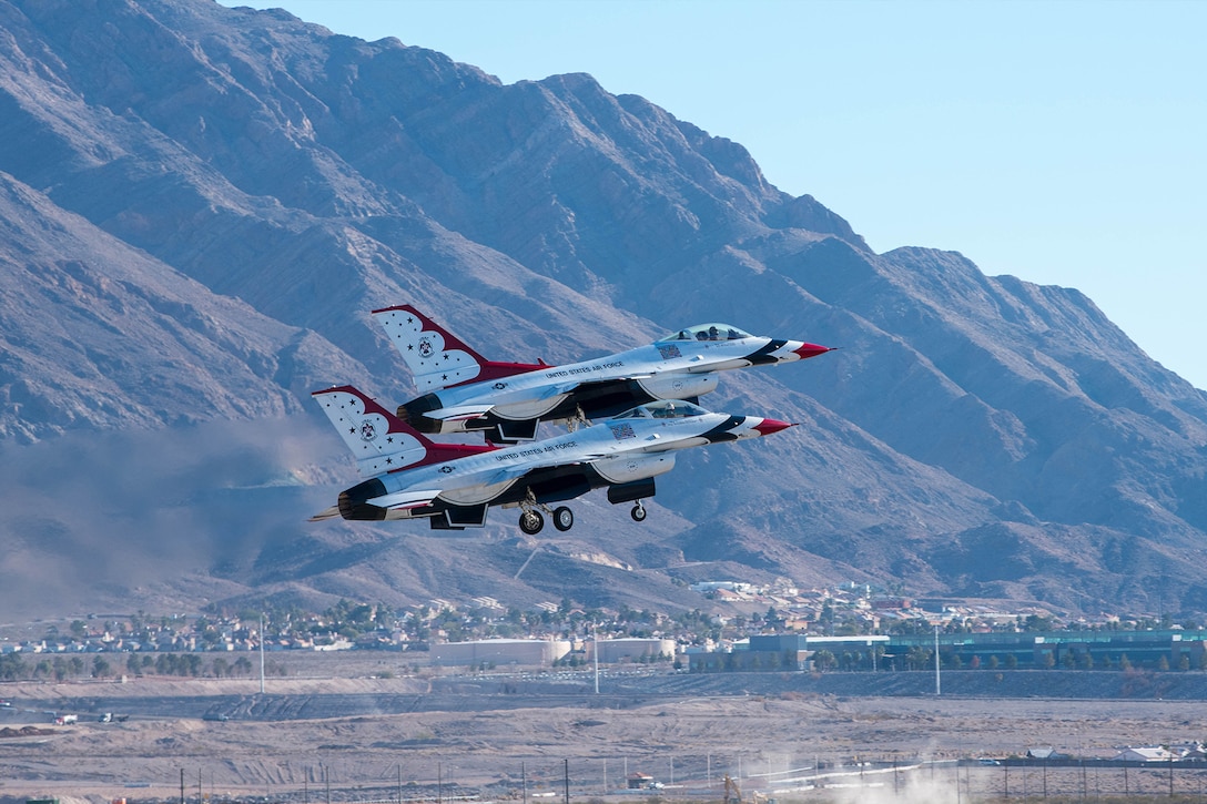 Air Force Thunderbirds fly next to each other.