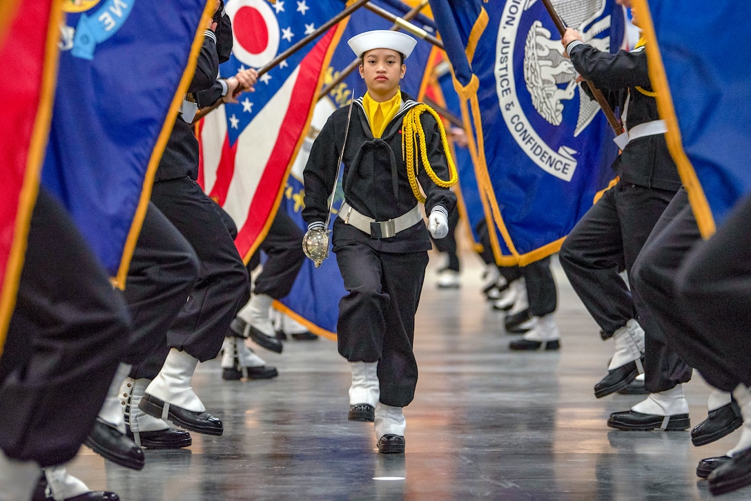 Navy performance division recruits carry state flags.