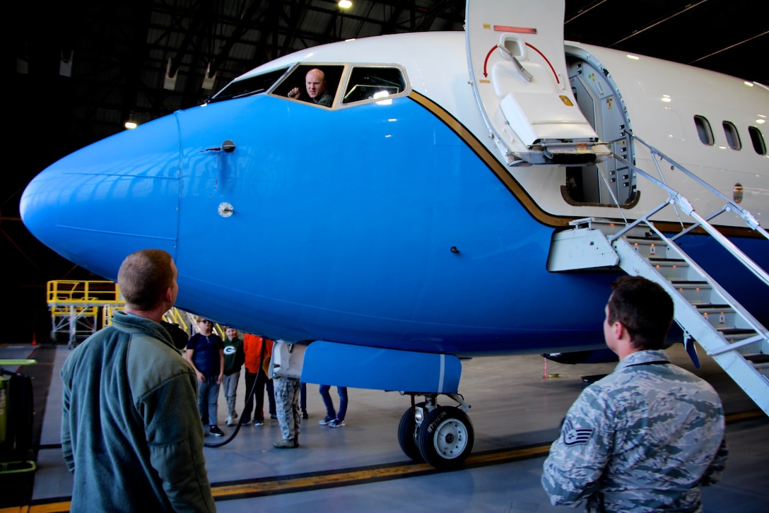 In the cockpit, Maj. Eric Butler, 54th Airlift Squadron C-40 pilot and Mission Support Flight commander, talks to 932nd Maintenance Group members Senior Airman Alex Jenkins, and Staff Sgt. David Schallenberg, as they prepare for a recent static display tour.  Butler has been recognized for leading Airmen in executing seven diverse support functions for the Total Force Association under the 932d Airlift Wing’s executive airlift mission. His main focus for the past several months has been updating the Flight Attendant Operations Center. Butler led the charge in coordinating requirements with the 375the Contracting Squadron and the 932nd Civil Engineer Squadron. During implementation of phase one, which involved $69,000 of upgraded equipment and remodeling, there was no degradation to missions or training.  Together, maintainers and pilots, spoke to STEM class students from Mascoutah as part of a Dec. 10, 2018 tour at Scott Air Force Base, Illinois.  (U.S. Air Force photo by Lt. Col. Stan Paregien)
