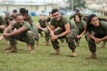 Marines and Sailors with Combat Logistics Regiment 3, 3rd Marine Logistics Group, squat during the physical training portion of Back in the Saddle (BITS) training on Jan. 4, 2019 at Camp Foster, Okinawa, Japan. CLR-3 integrated physical training with BITS training in order to create an interactive learning experience. (U.S. Marine Corps photo by Lance Cpl. Armando Elizalde)