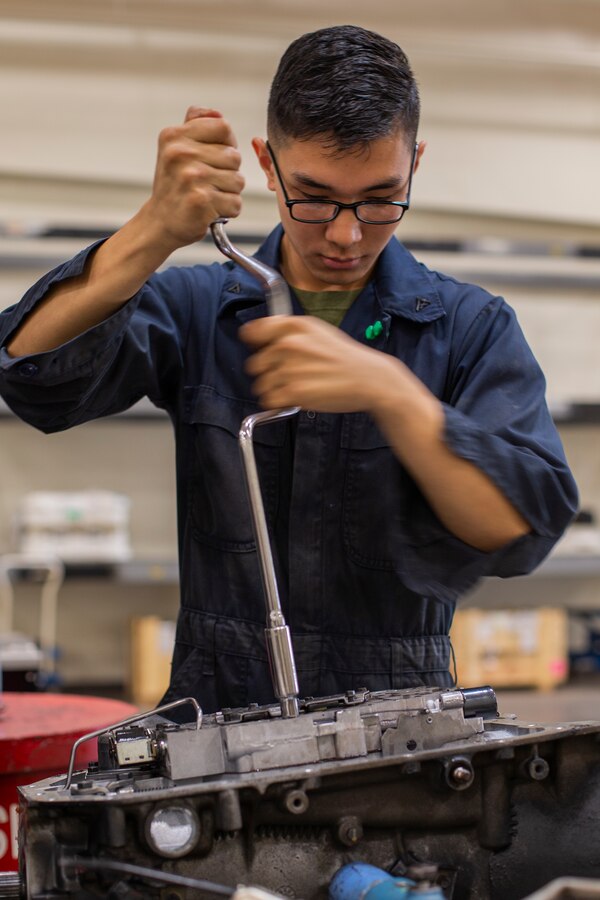 Lance Cpl. Timoor Mchugh extracts a bolt using a speed handle Jan. 8, 2019, at Camp Kinser, Okinawa, Japan. Marines with Component Repair Platoon, General Support Maintenance Company, 3rd Maintenance Battalion, Combat Logistics Regiment 35, 3rd Marine Logistics Group, clean, rebuild and repair parts of motor vehicles to ensure that they are serviceable. Mchugh, a native of Houston, Texas, is a motor transportation mechanic with CRP, GSM Co., 3rd Maint. Bn., CLR-35, 3rd MLG. (U.S. Marine Corps photo by Lance Cpl. Terry Wong)