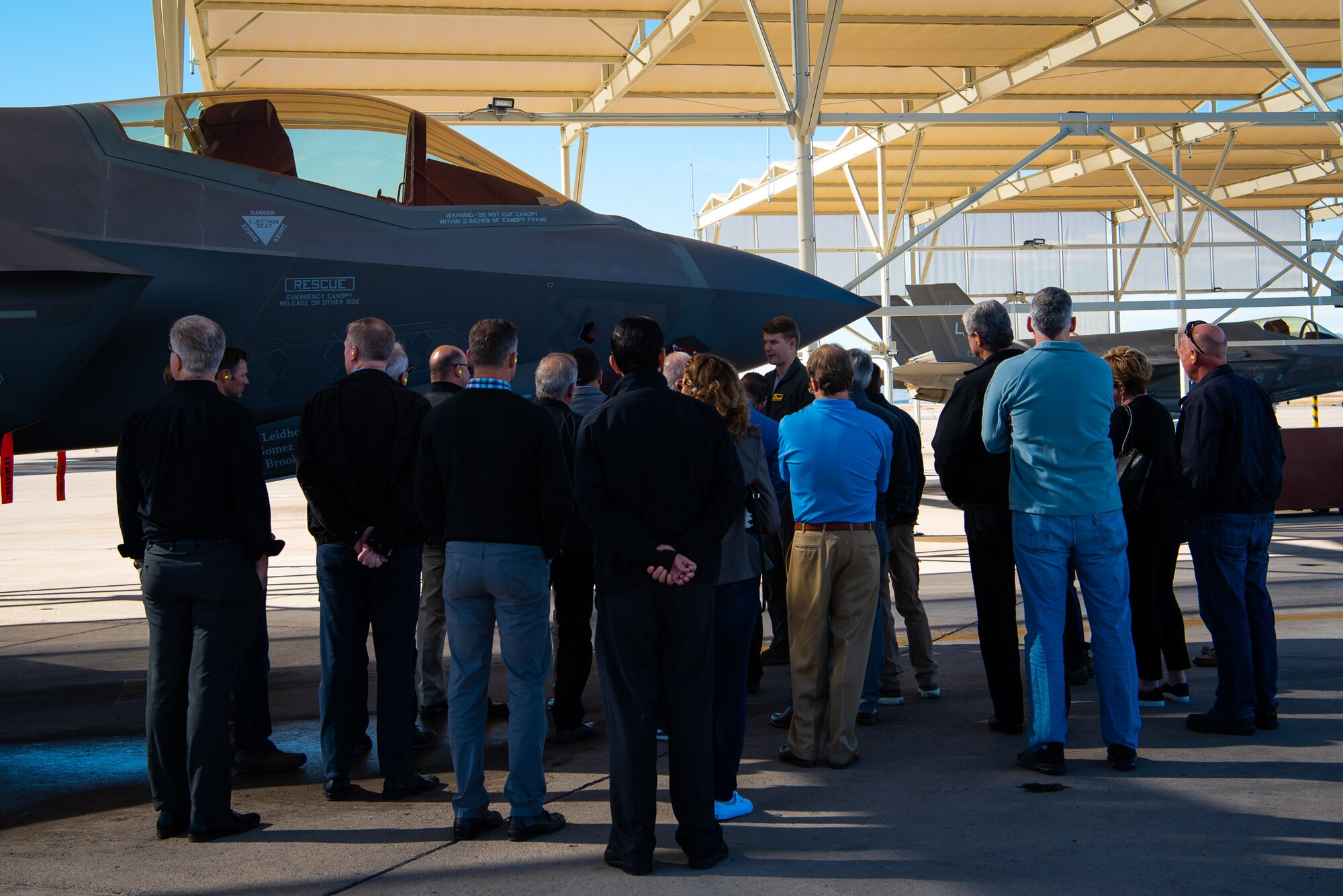 Honorary Commanders receive a briefing on the F-35A Lightning II during a base tour at Luke Air Force Base, Ariz., Jan. 8, 2019.