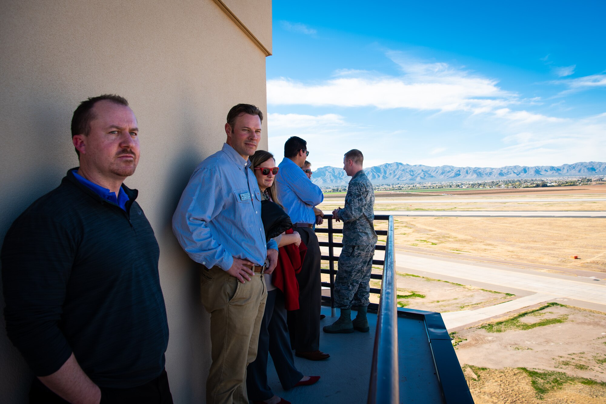 Honorary Commanders stand on top of the air traffic control tower during a base tour at Luke Air Force Base, Ariz., Jan. 8, 2019.