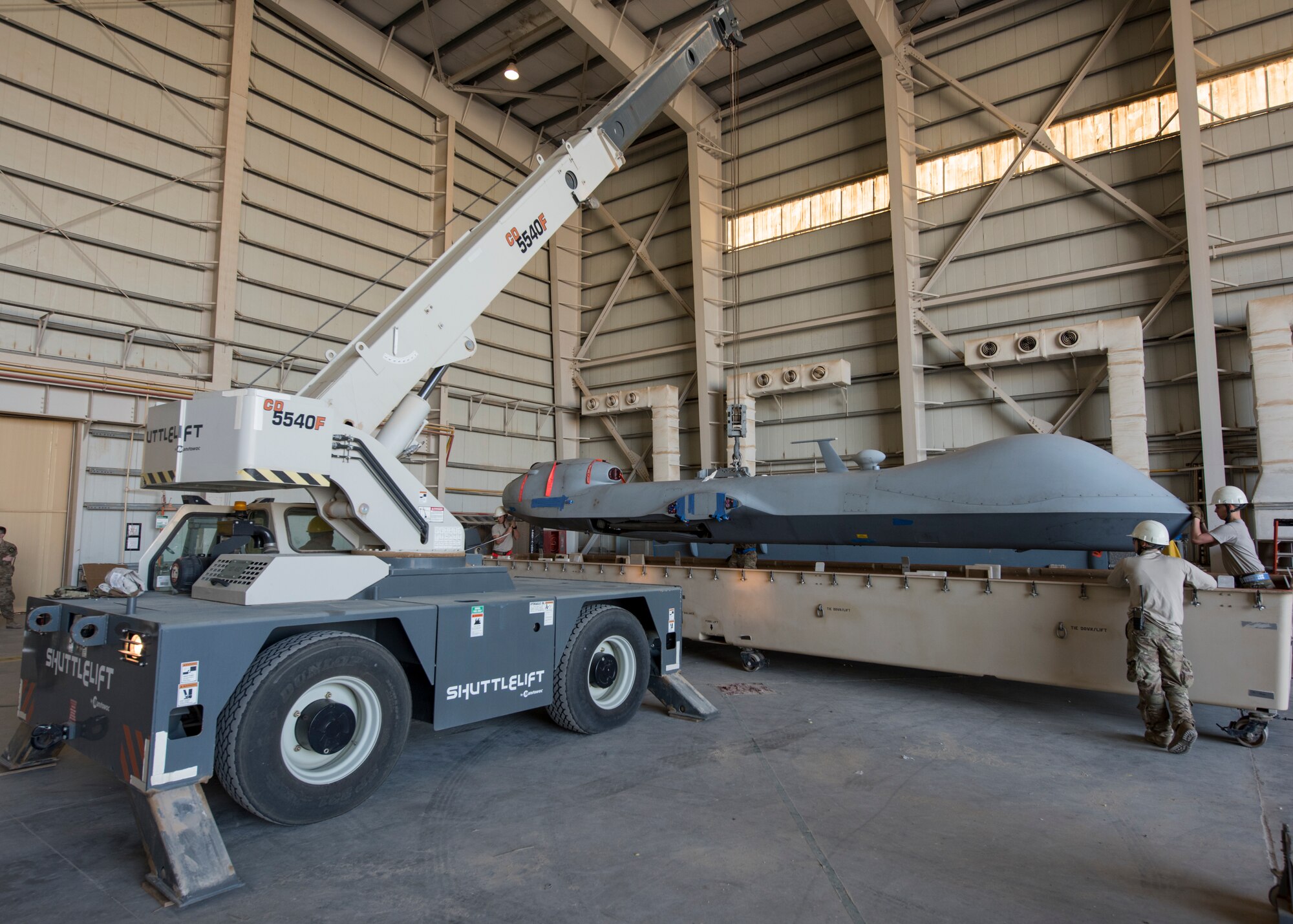 A crane lifts a MQ-9 Blk 1ER Reaper from the delivery crate Dec. 16, 2018, at an undisclosed location in Southwest Asia. The Reapers that are being replaced will be sent back to their respected units to be retrofitted with the upgrades.