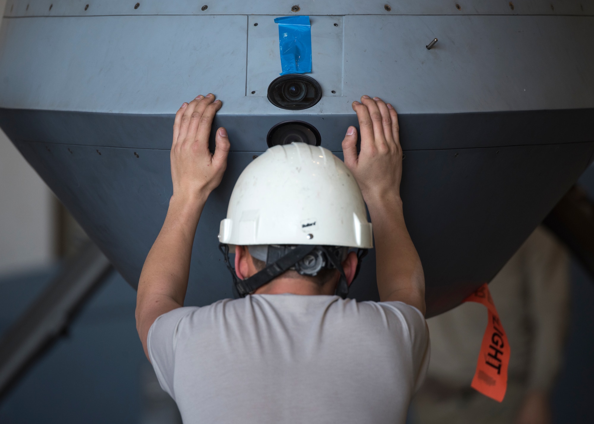 An Airman helps balance a MQ-9 Blk 1ER as a crane lowers it after removing it from the crate on Dec. 16, 2018, at an undisclosed location in Southwest Asia. The new drones were upgraded with a different engine that has n Alcohol Water Injection system and a four- blade prop to increase thrust for shorter runways and heavier airframe weight.