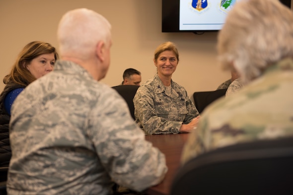 Lt. Gen. L. Scott Rice, director of the Air National Guard sits at a board table with 102nd Intelligence Wing leadership.
