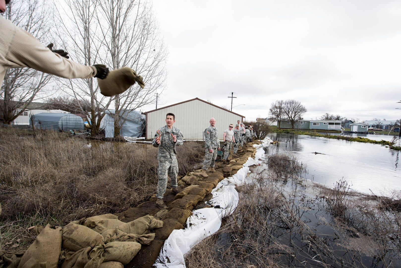 Airmen and Soldiers of the Washington National Guard assist with sandbagging during the 2017 flooding in Sprague, Wash.