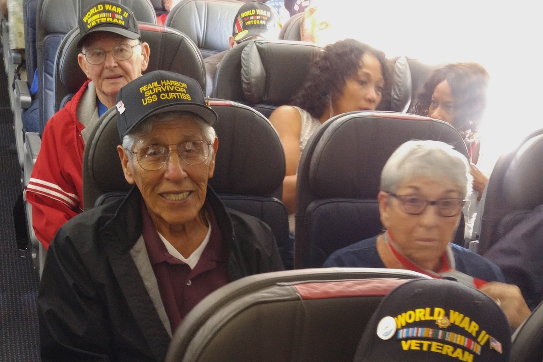 World War II veterans relax on a plane to Hawaii.