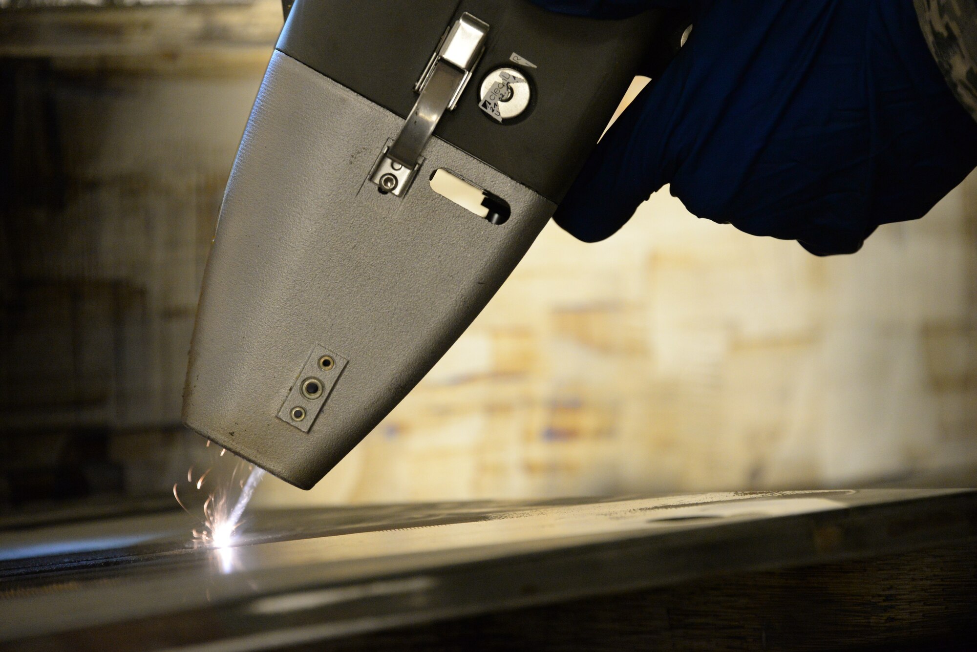 Airman 1st Class Levi Gordon, 60th Maintenance Squadron aircraft structural maintenance, uses a Clean Laser 1000 to remove paint from a sheet of metal March 7, 2018 at Travis Air Force Base, Calif. The 1000-watt laser can remove paint and corrosion. It reduces the waste created from sanding paint by 90 percent. Travis was chosen as one of two bases to test the capabilities of the laser. (U.S. Air Force photos by Staff Sgt. Amber Carter)