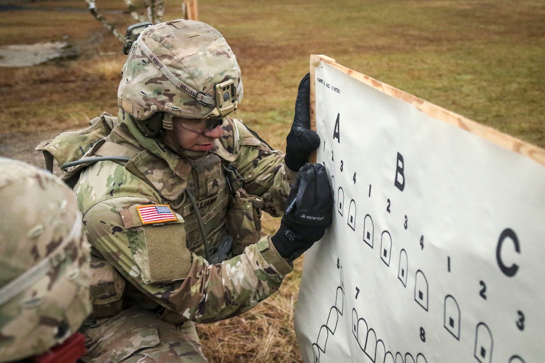 A soldier marks a target sheet.