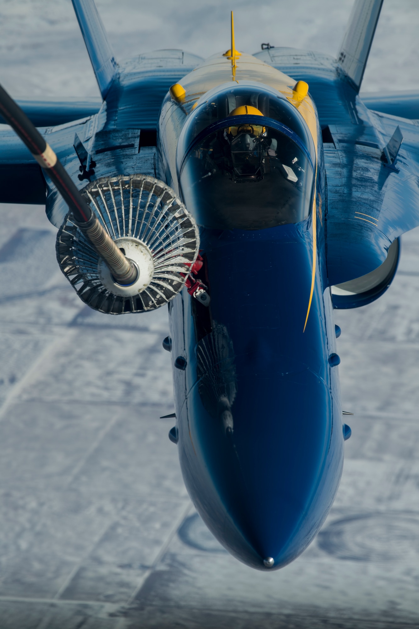 A U.S. Air Force KC-10 Extender, crewed by Reserve Citizen Airmen with the 78th Air Refueling Squadron, 514th Air Mobility Wing, extends a drogue to refuel an F-18 piloted by the U.S. Navy Flight Demonstration Team, the Blue Angels, over the mid-western U.S., January 3, 2018.