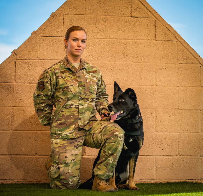 Senior Airman Amber Gordon, 56th Security Forces Squadron military working dog handler, poses for a portrait with her MWD, Boss, at Luke Air Force Base, Ariz., Jan. 7, 2019. The MWD handler is responsible for protecting and defending military installations with their loyal canine partner by their side. (U.S. Air Force photo by Senior Airman Alexander Cook)