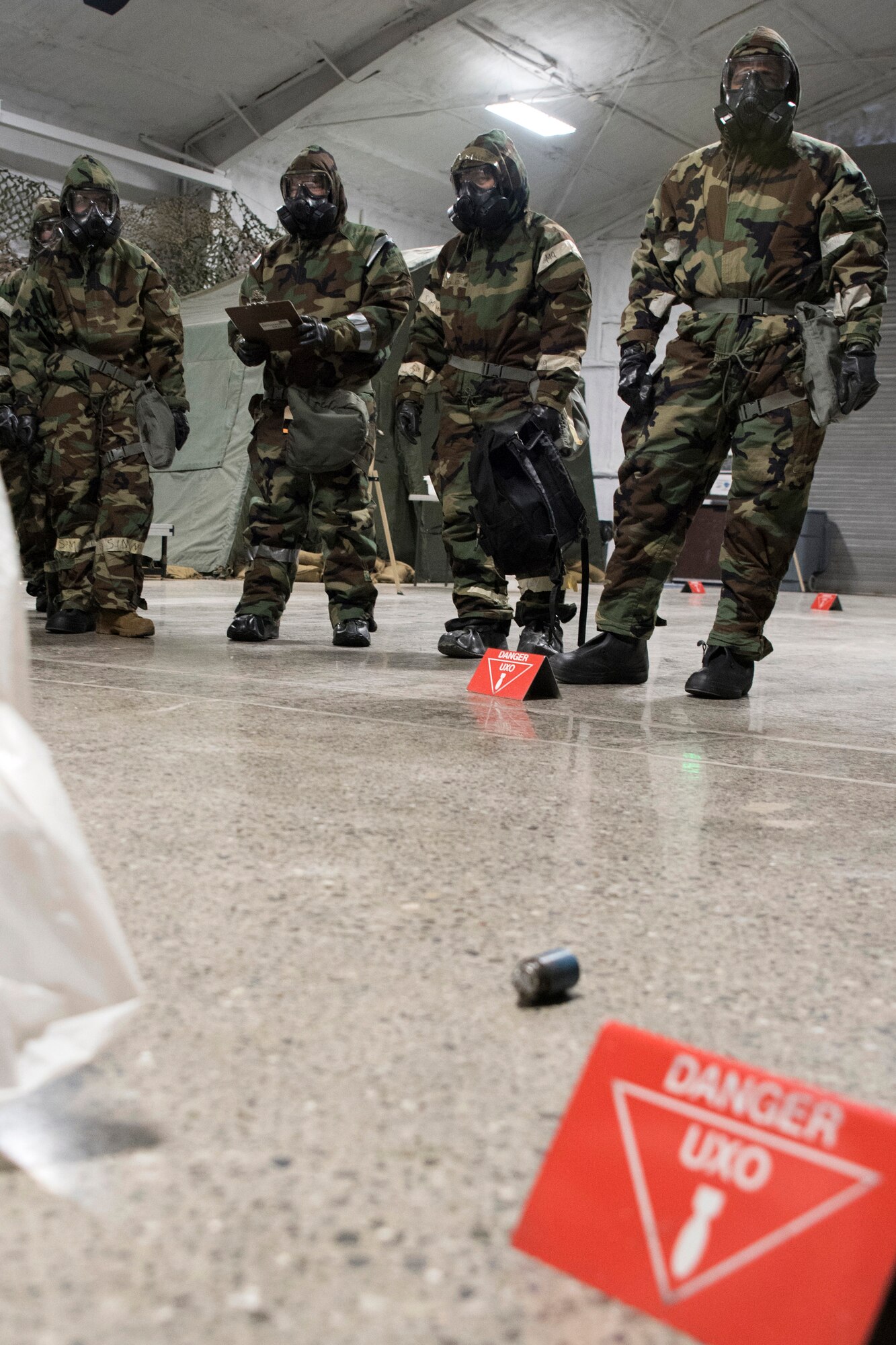 A group of U.S. Air Force Airmen cordon an area after a simulated initial release during a newly-implemented chemical, biological, radiological and nuclear defense training course exercise at Joint Base Elmendorf-Richardson, Alaska, Jan. 8, 2019. One of the key changes made embraces the reintegration of hands-on, in-person instruction, and reduces computer based training, allowing Airmen to receive a more tailored learning experience. (U.S. Air Force photo by Airman 1st Class Crystal A. Jenkins)