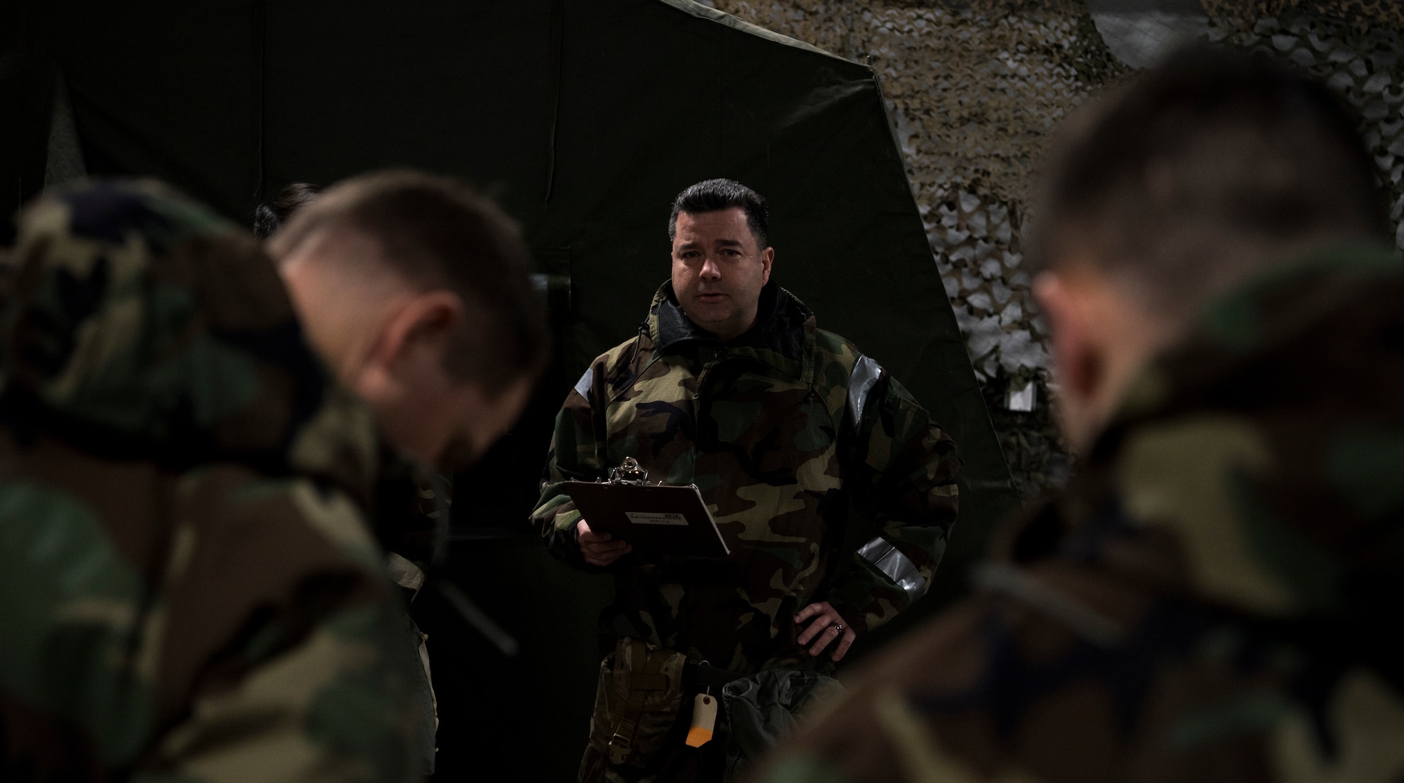 U.S. Air Force Master. Sgt. Joseph Connolly, 732nd Air Mobility Squadron superintendent of air freight operations, directs classmates on proper procedures during a newly-implemented chemical, biological, radiological and nuclear defense training course drill at Joint Base Elmendorf-Richardson, Alaska, Jan. 8, 2019. One of the key changes made embraces the reintegration of hands-on, in-person instruction, and reduces computer based training, allowing Airmen to receive a more tailored learning experience. (U.S. Air Force photo by Airman 1st Class Crystal A. Jenkins)